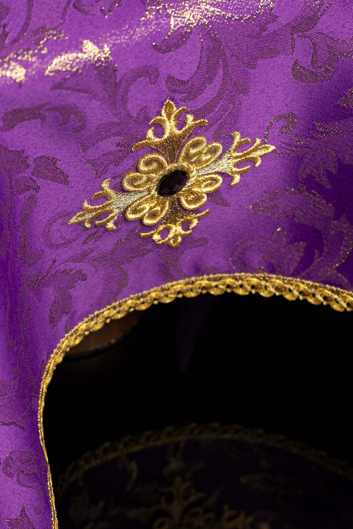 Detail view of the chalice veil showing embroidered gold cross and scalloped gold trim
