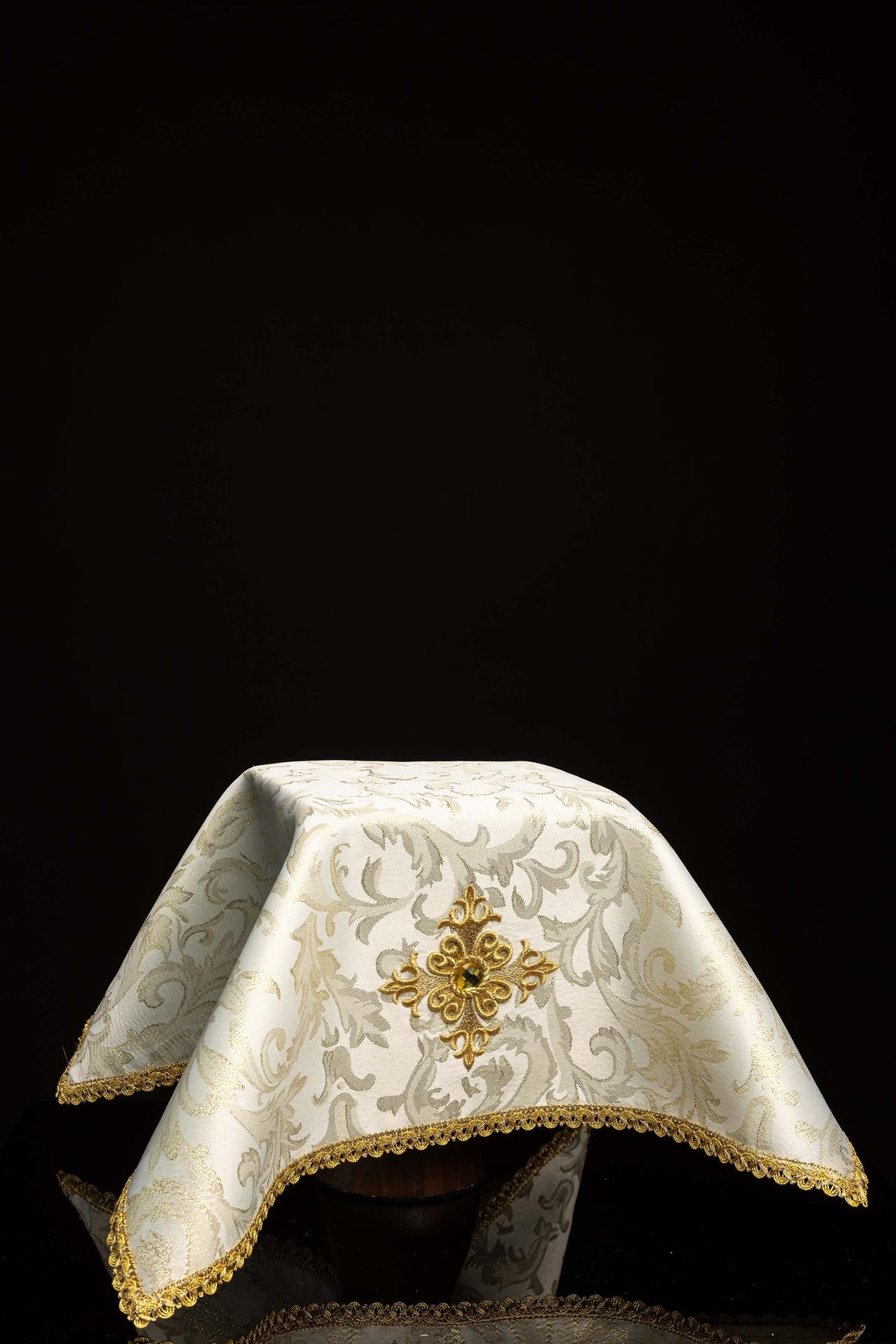 Front view of Ecru Chalice Veil Embroidered with a Gold Cross with gold trim and ornate woven pattern