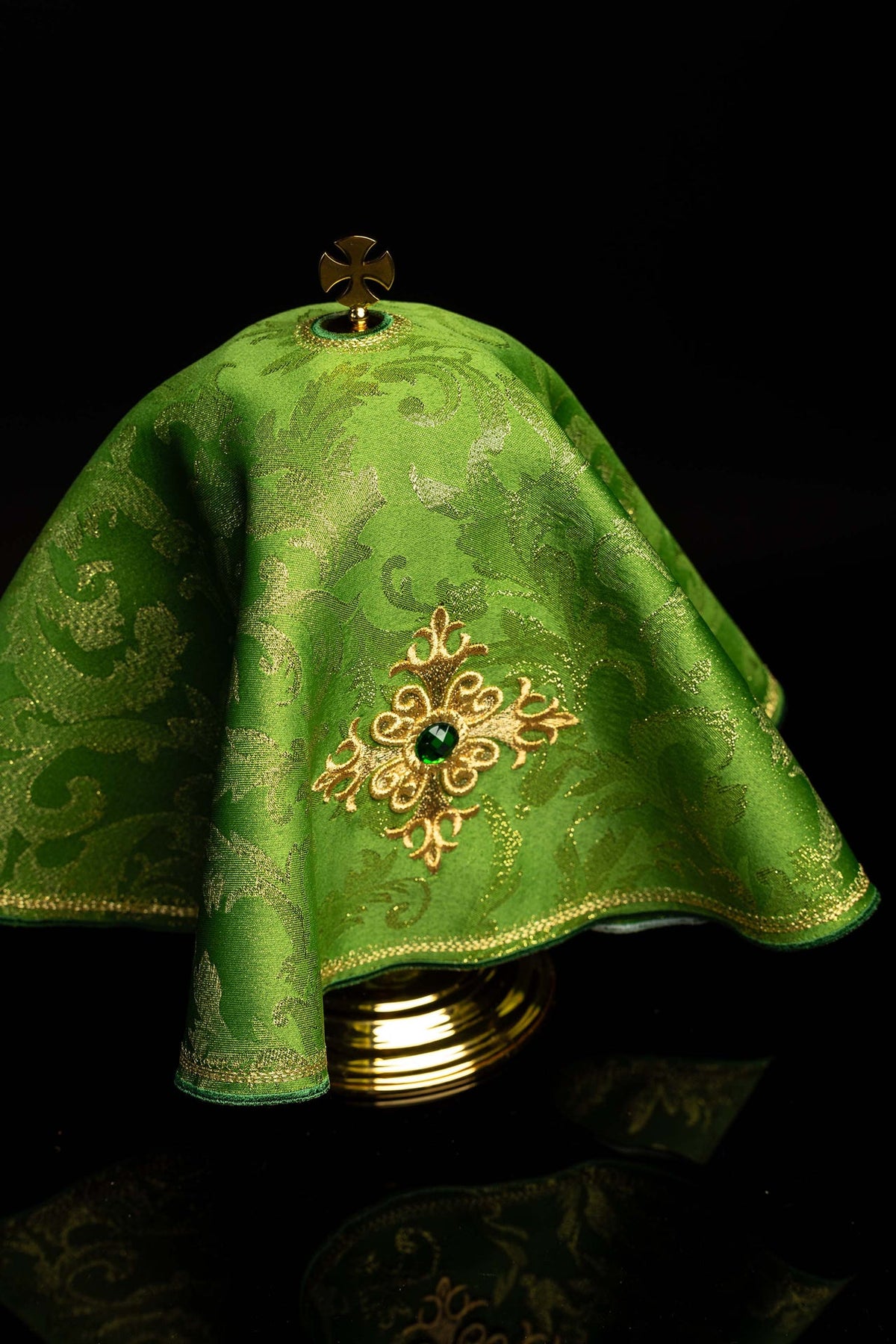 Angled view of the green ciborium veil with embroidered cross and green stone