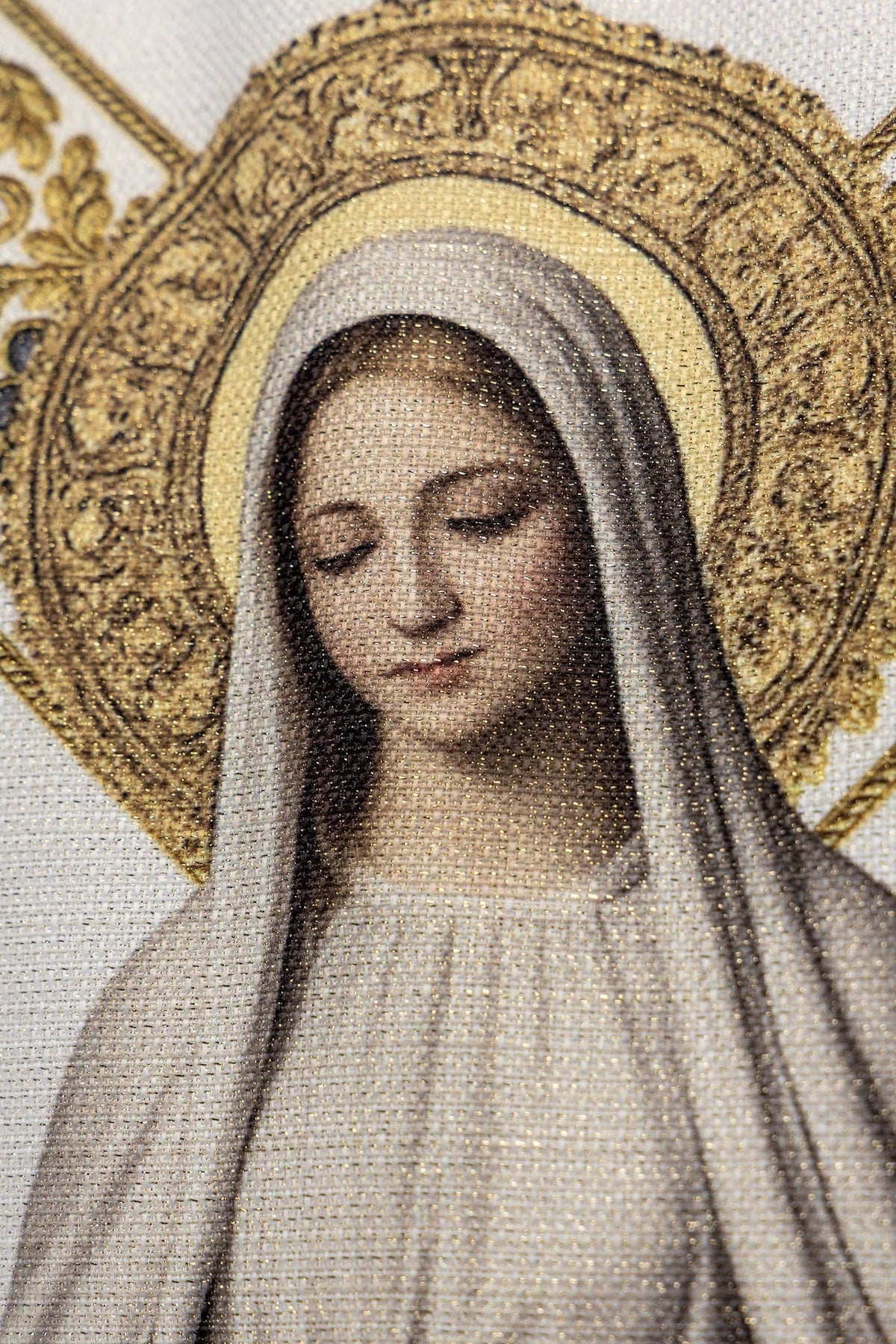 Close-up of the chasuble showing Our Lady of Lourdes and blue floral border