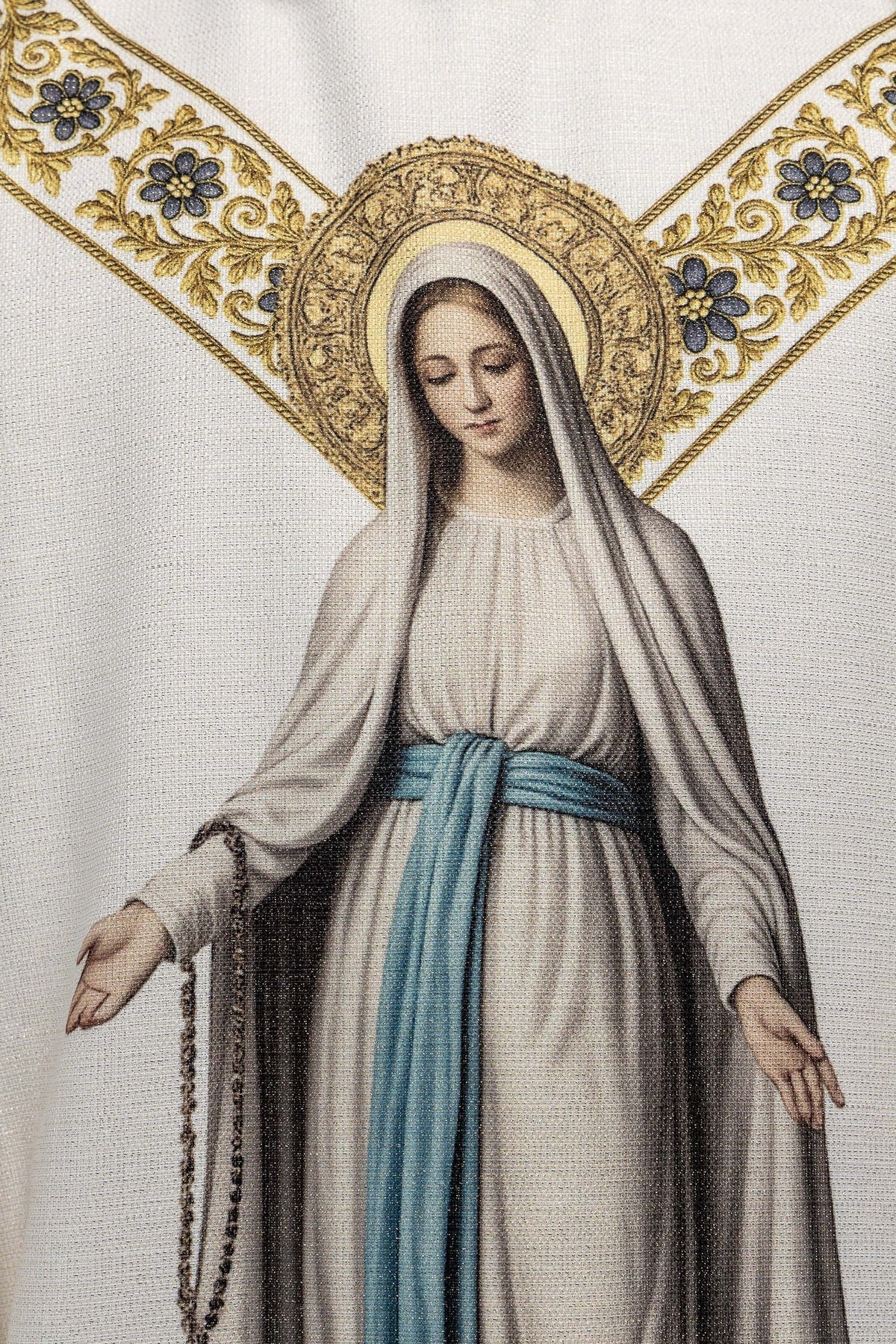 Detail of the chasuble print showing Our Lady of Lourdes and her gold halo