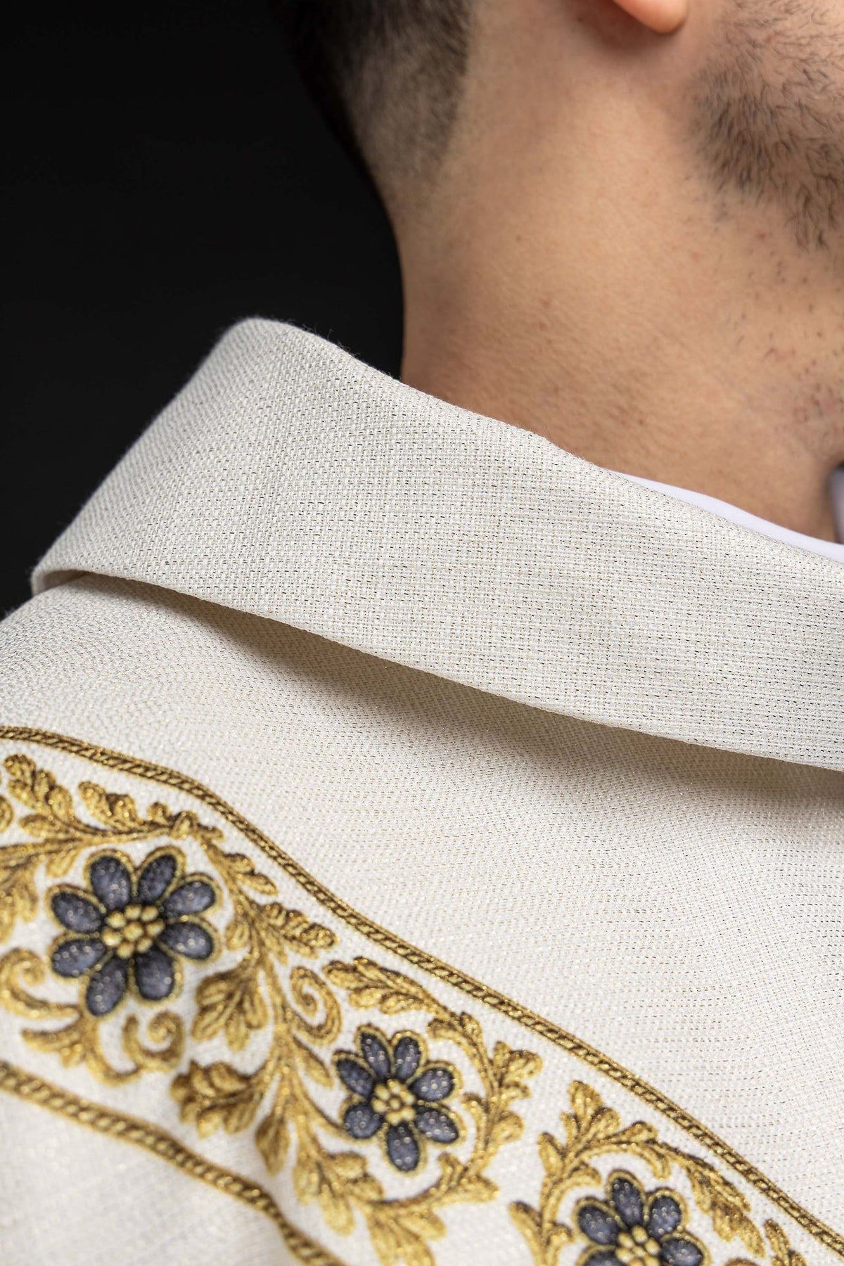 Close-up of the ecru chasuble sleeve with gold edge trim