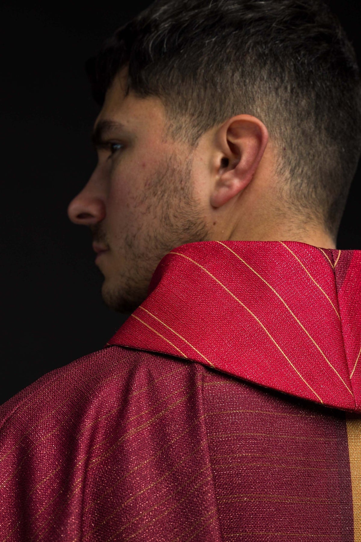 Collar close-up of the red chasuble with fine gold horizontal stripes
