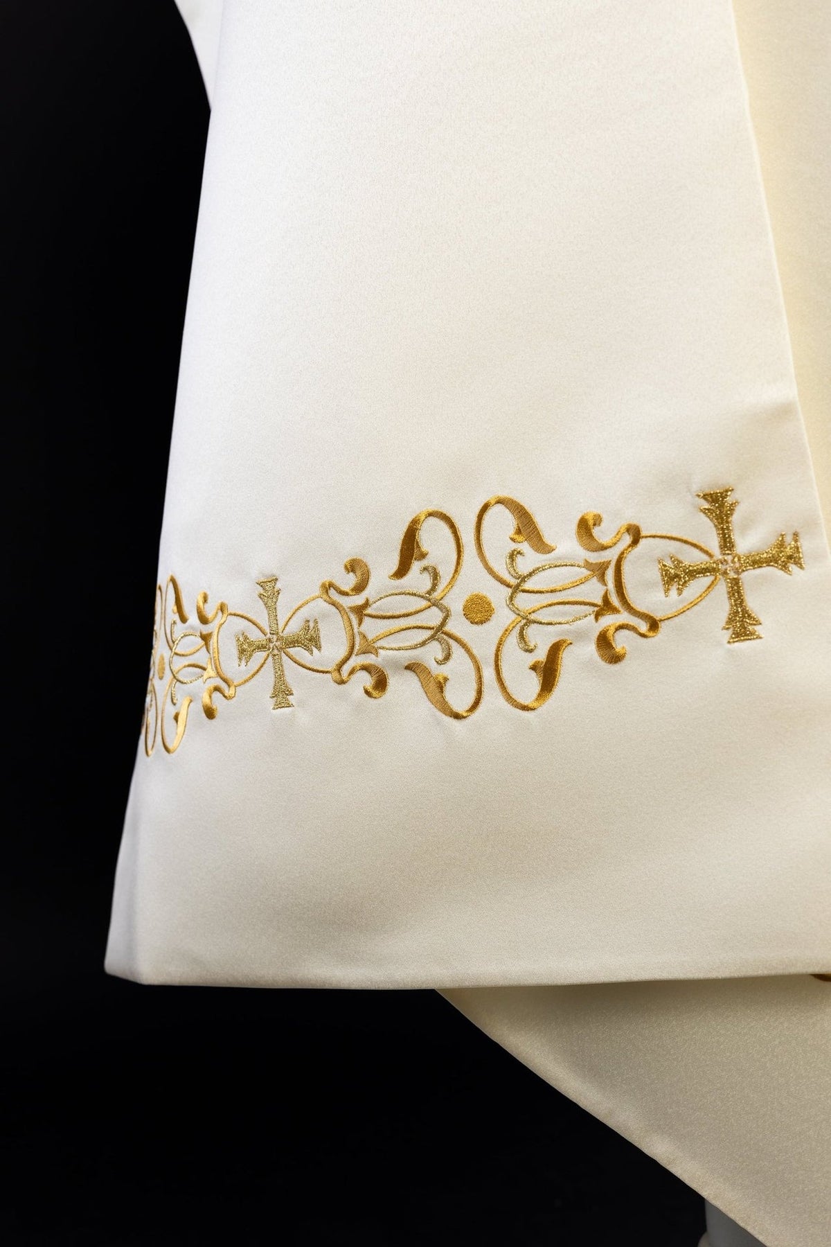 Close-up of ecru humeral veil with gold floral embroidery and crosses