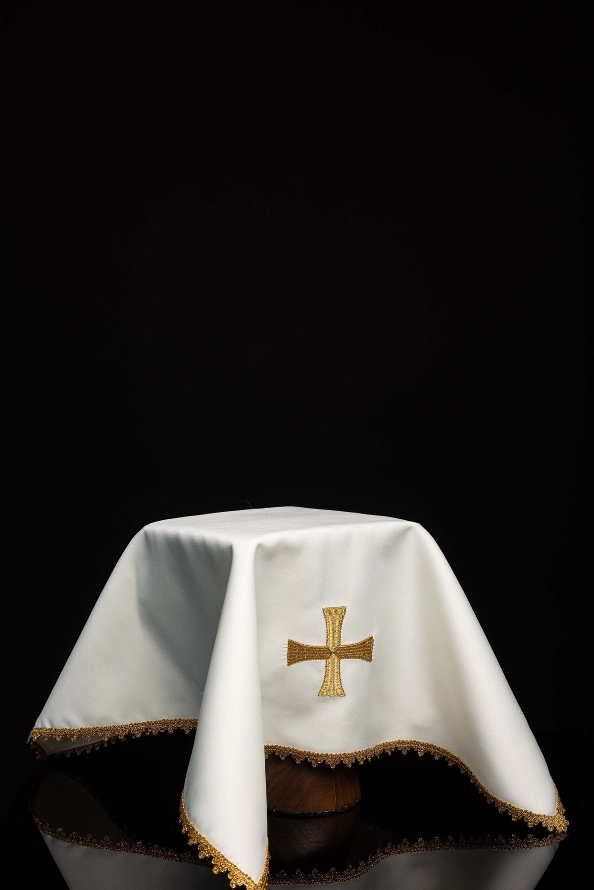 Worn white chalice veil with gold cross embroidery and scalloped gold trim
