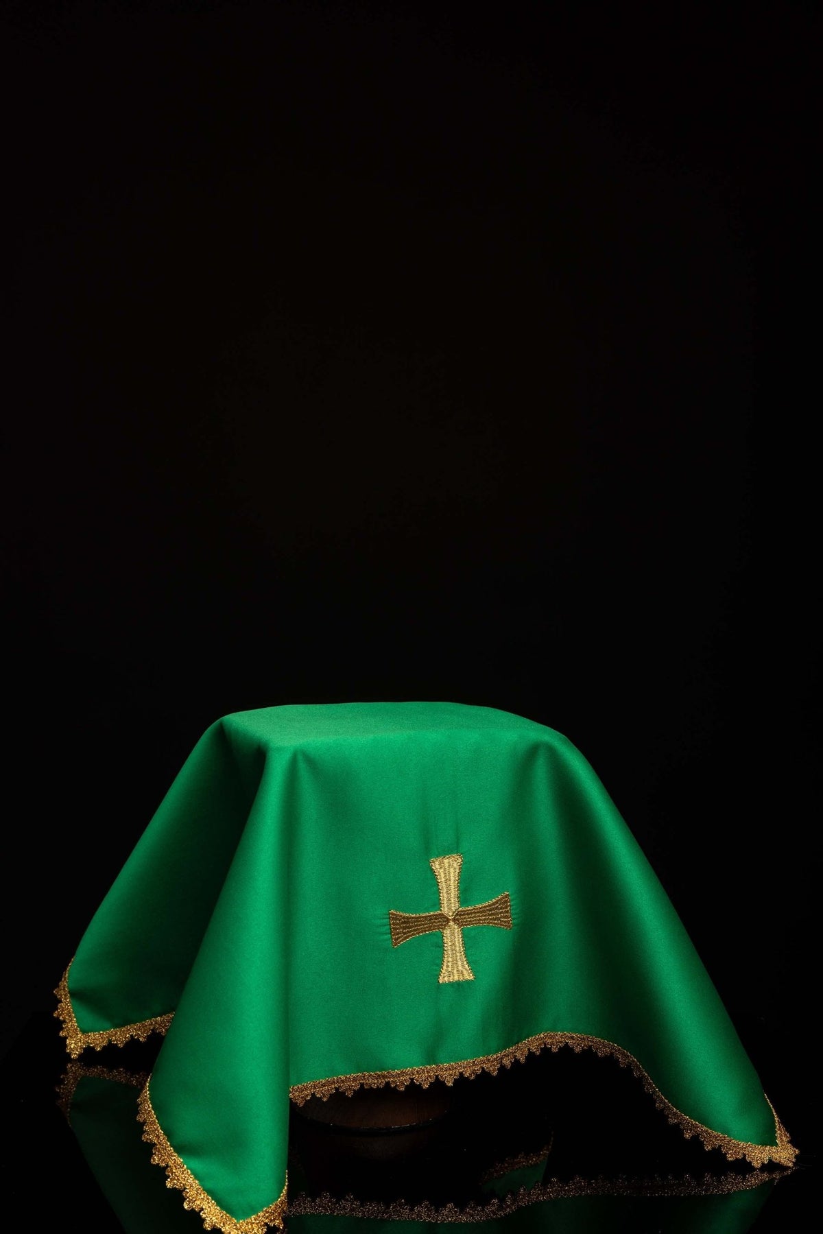 Worn green chalice veil with gold cross embroidery and scalloped gold trim