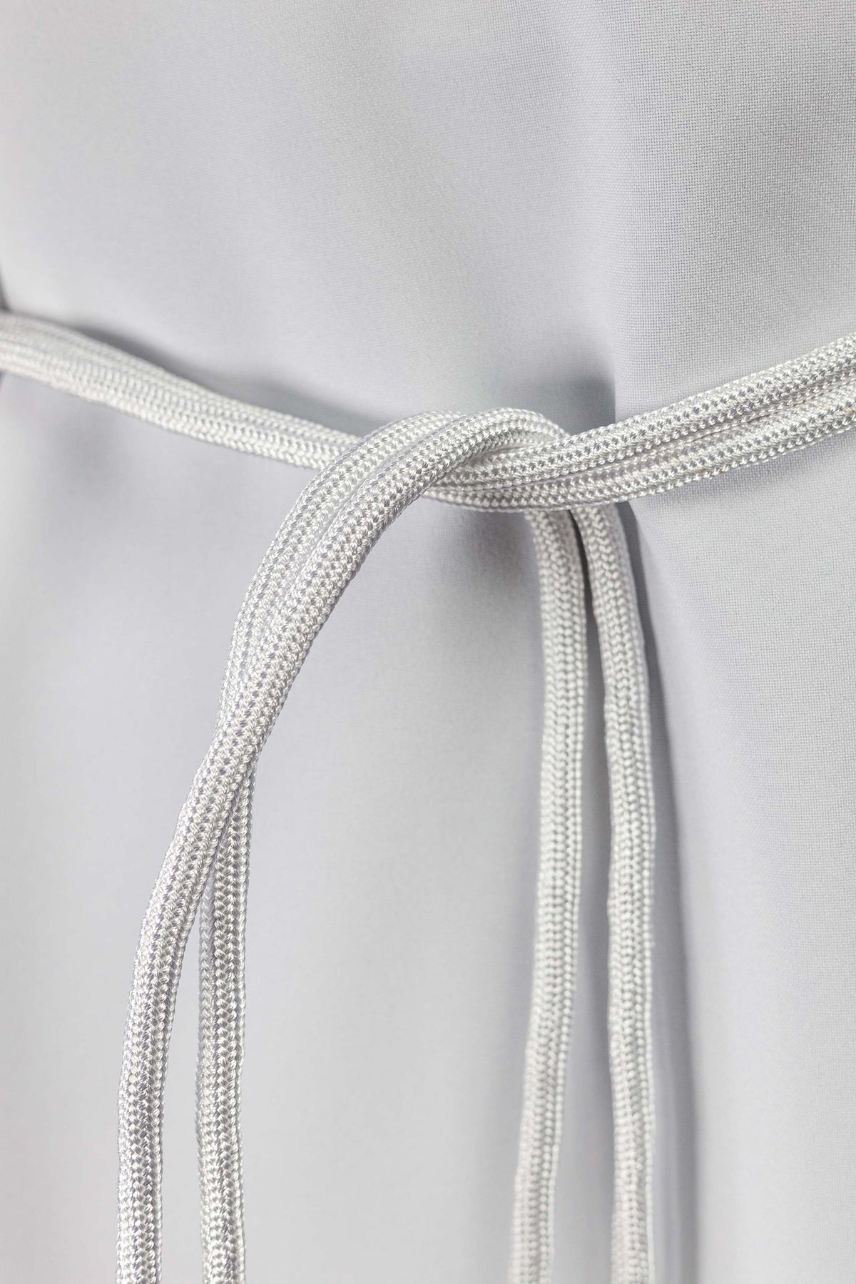 Close-up of the white liturgical cincture's braided cord
