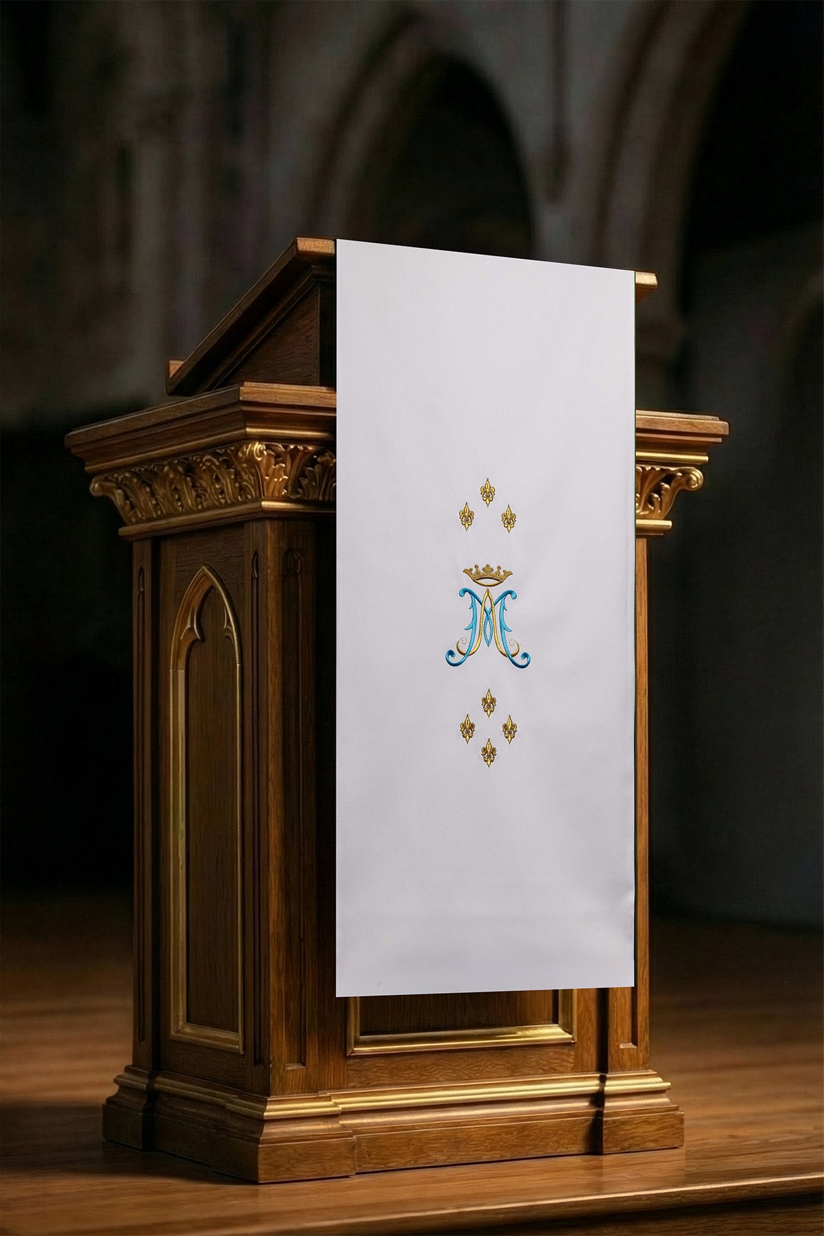 White lectern cover embroidered with a white Marian motif