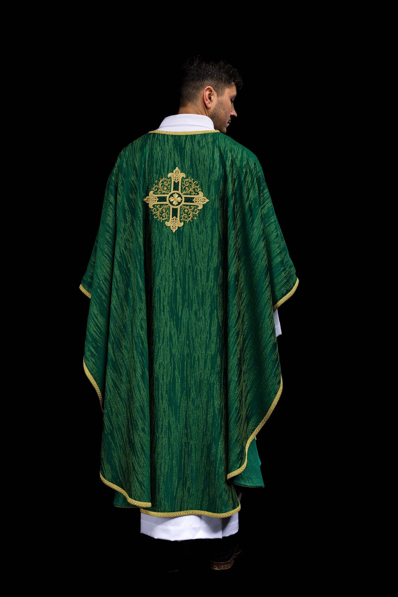 Green chasuble with embroidered cross motif on decorative fabric