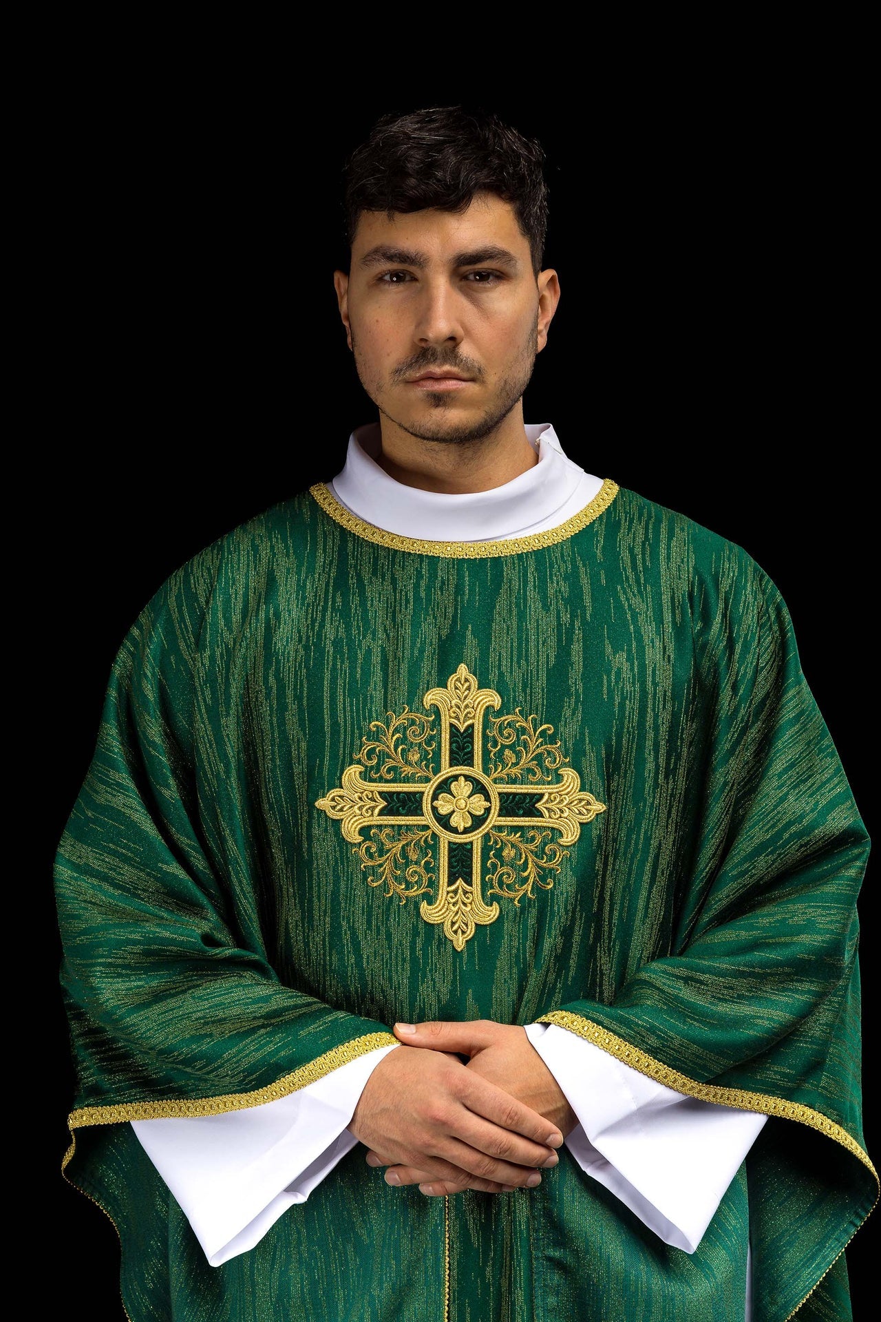 Green chasuble with embroidered cross motif on decorative fabric