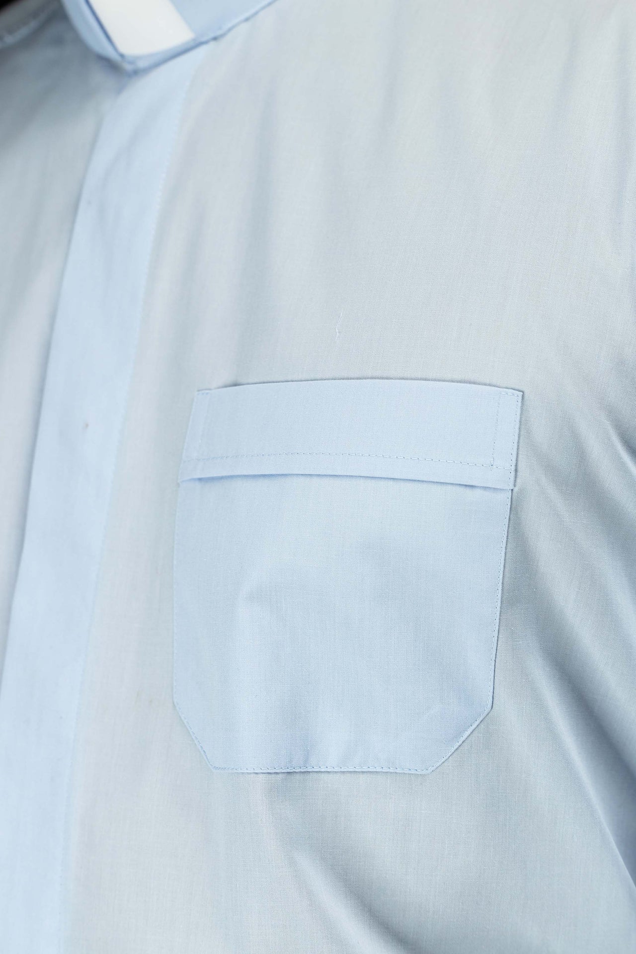 Blue long-sleeved clerical shirt with clerical collar