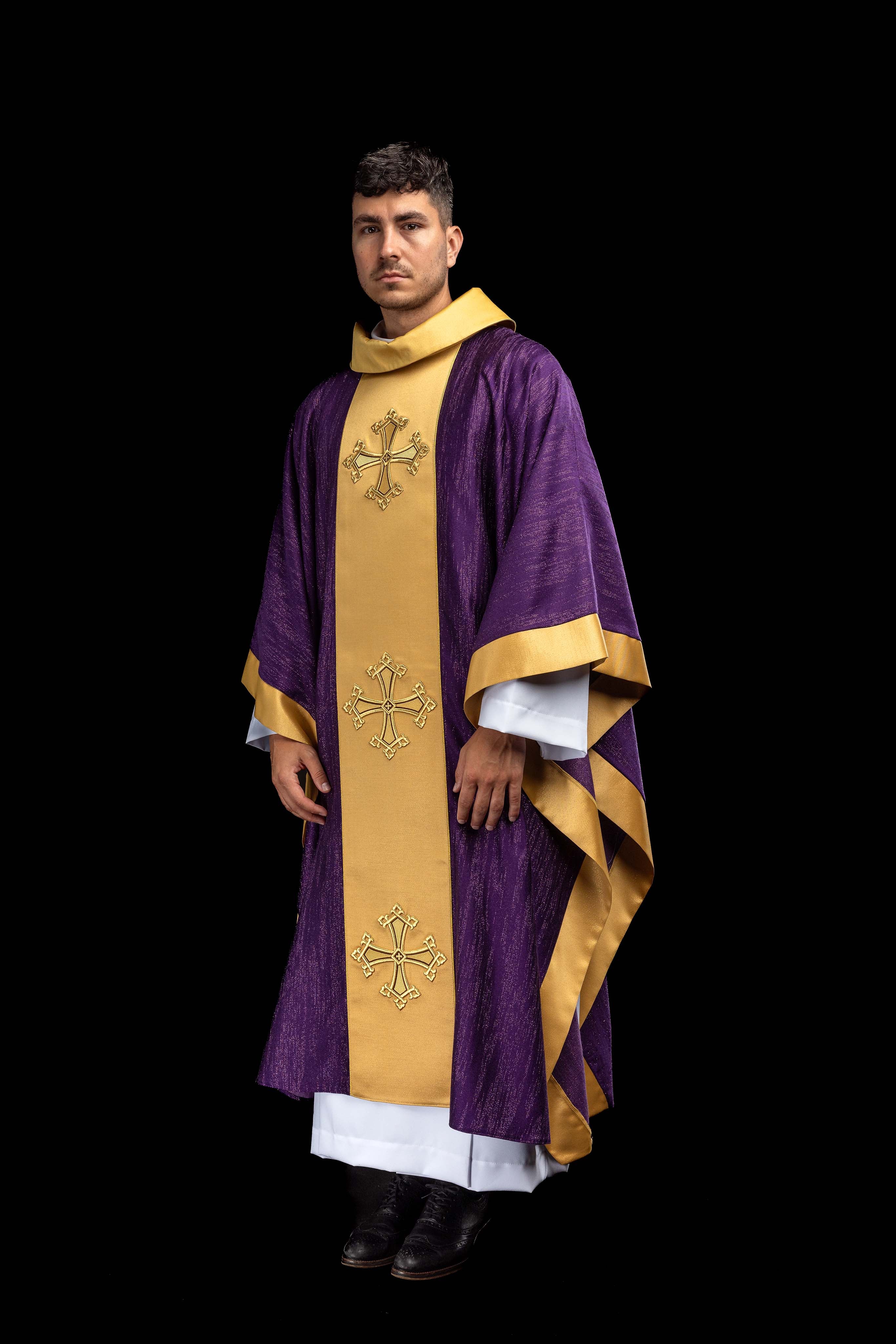 Purple chasuble with an embroidered cross motif and band on decorative fabric