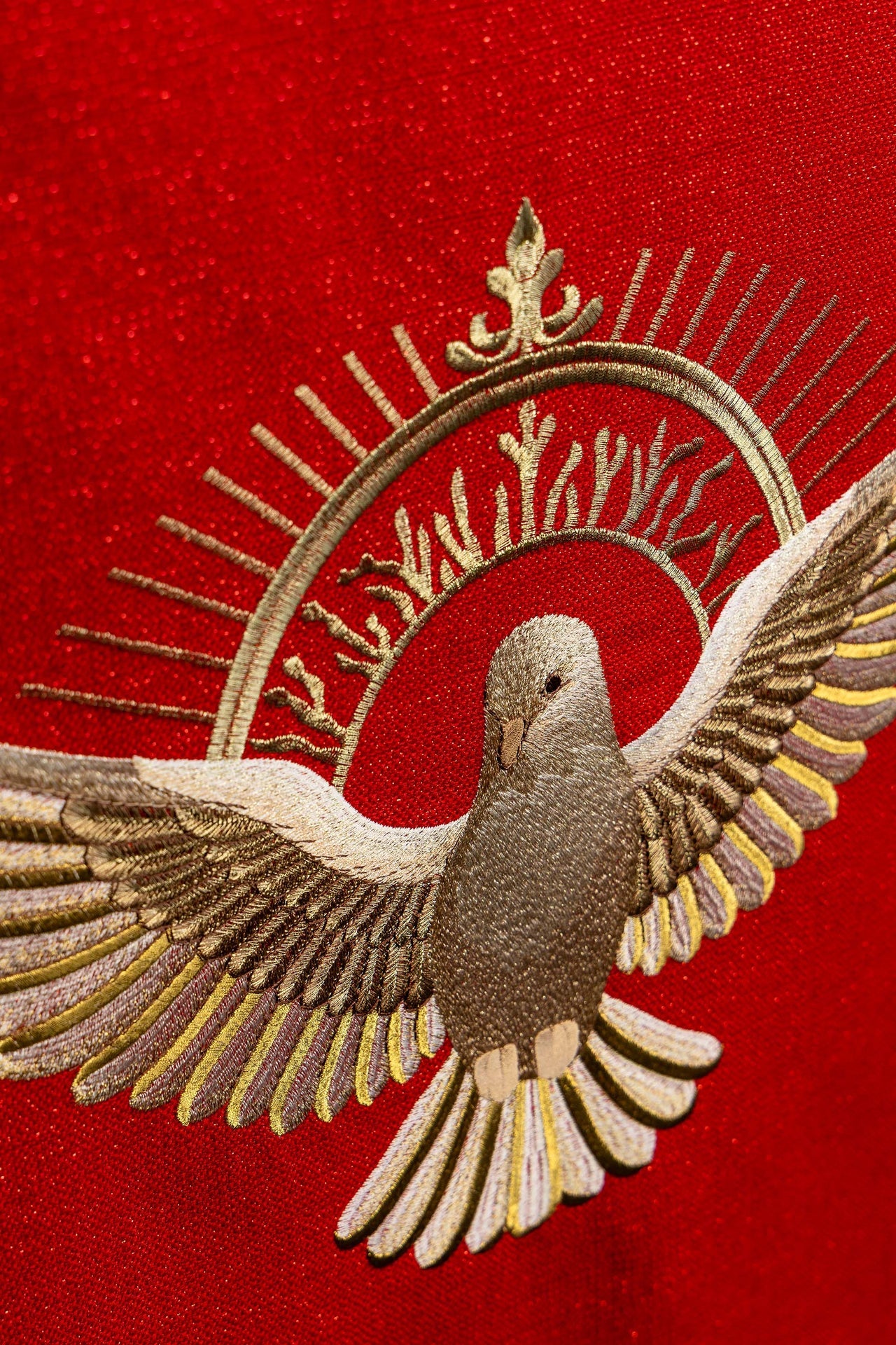 Red embroidered lectern cloth with the symbol of the dove and flames