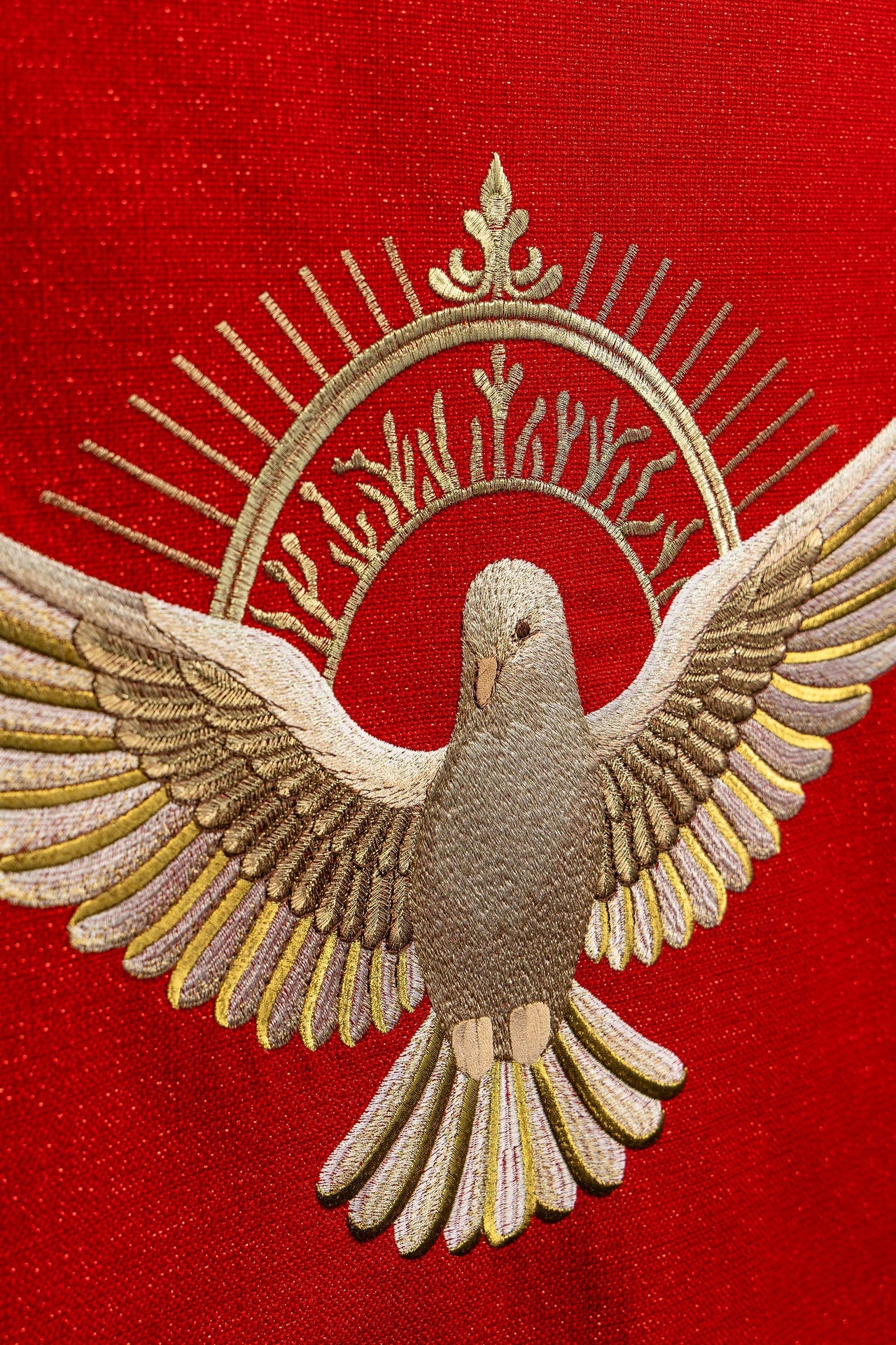Red embroidered lectern cloth with the symbol of the dove and flames