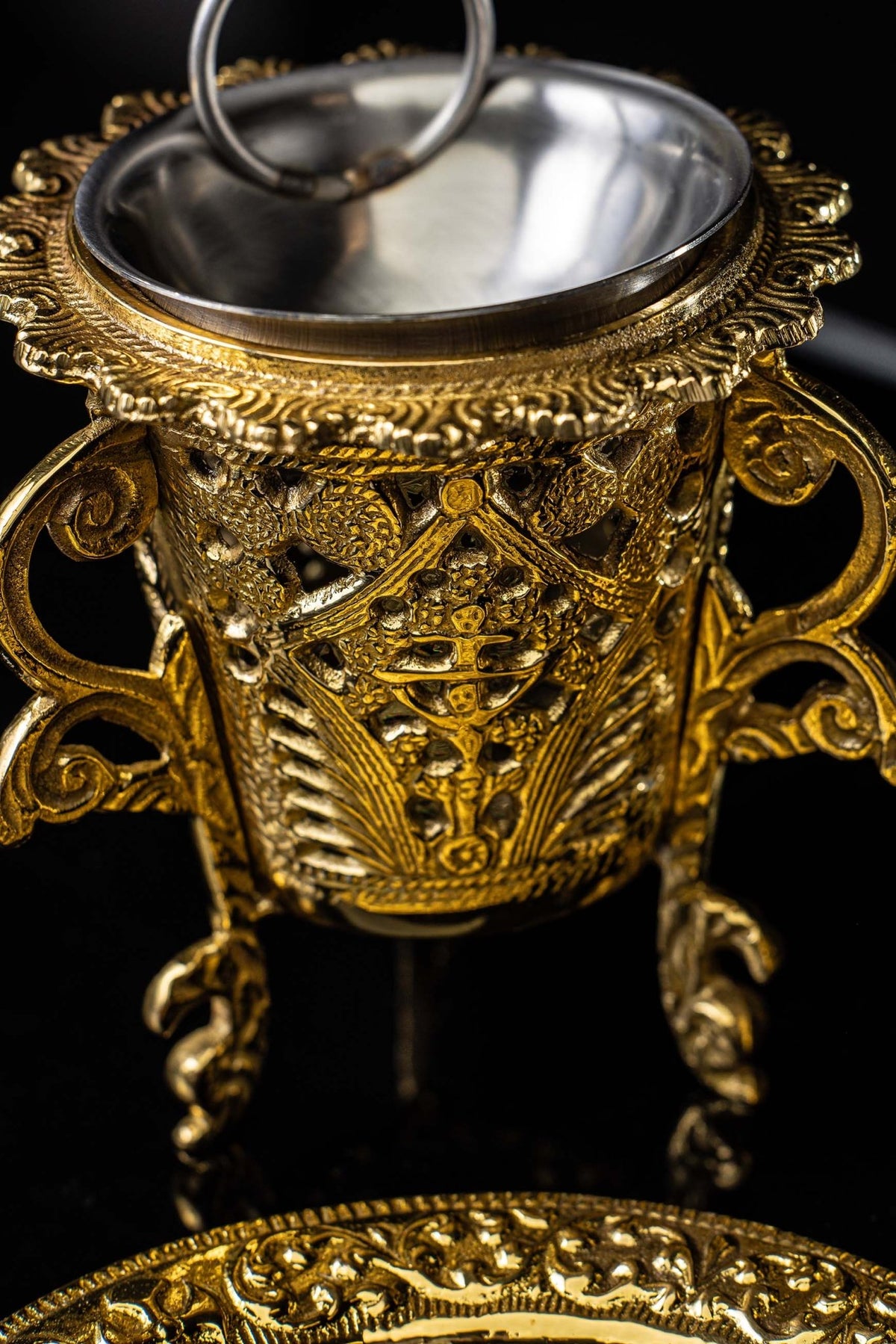 Close-up of the Brass Incense Burner interior bowl, decorative rim, and hanging ring