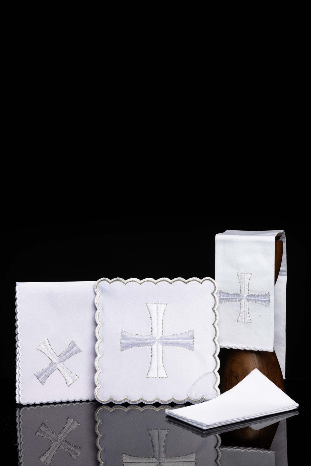 Front view of Chalice Linens with simple white embroidered Motif, showing white linens with scalloped edges and crosses