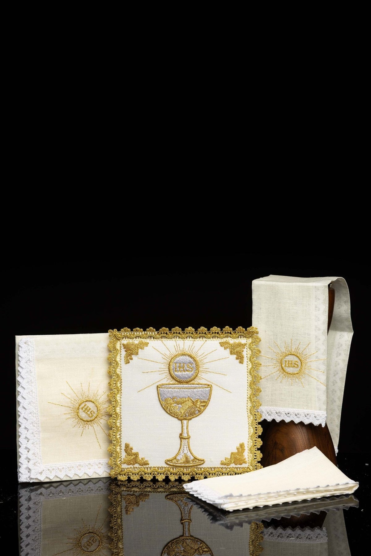 Front view of Chalice Set with Golden Chalice Motif and IHS, ivory linens with gold embroidery and white lace