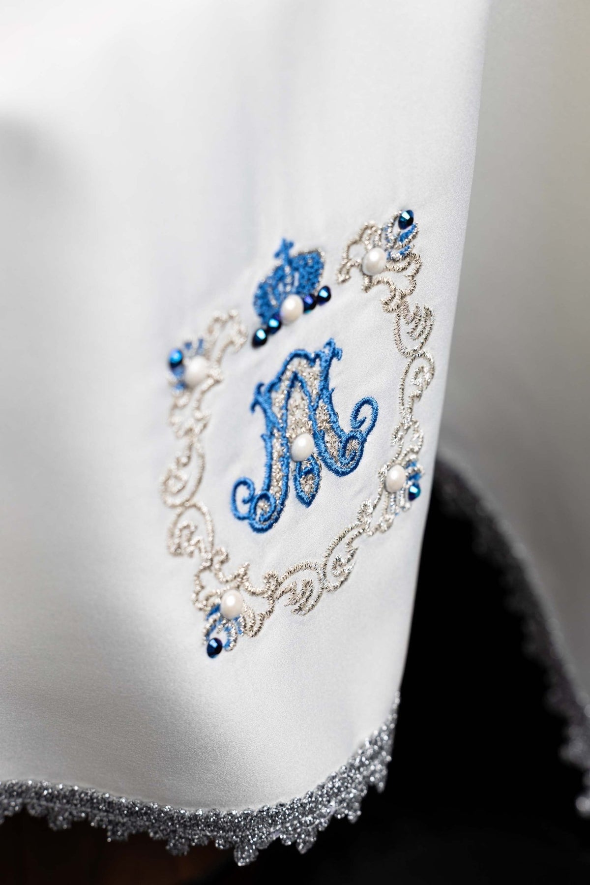 Close-up of the Chalice veil with Marian embroidery, blue Marian monogram with pearls and jeweled silver design