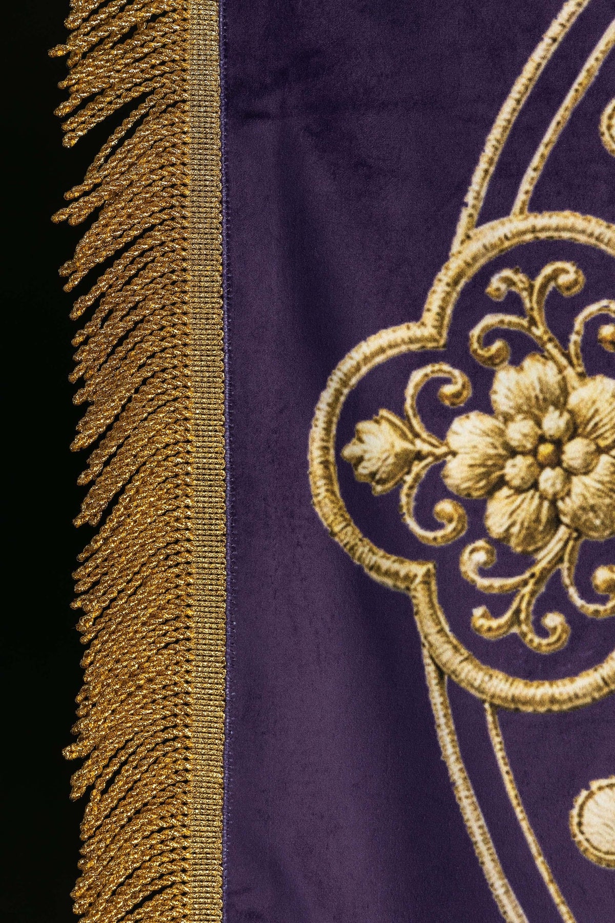 Close-up of the purple banner showing gold fringe and floral back motif