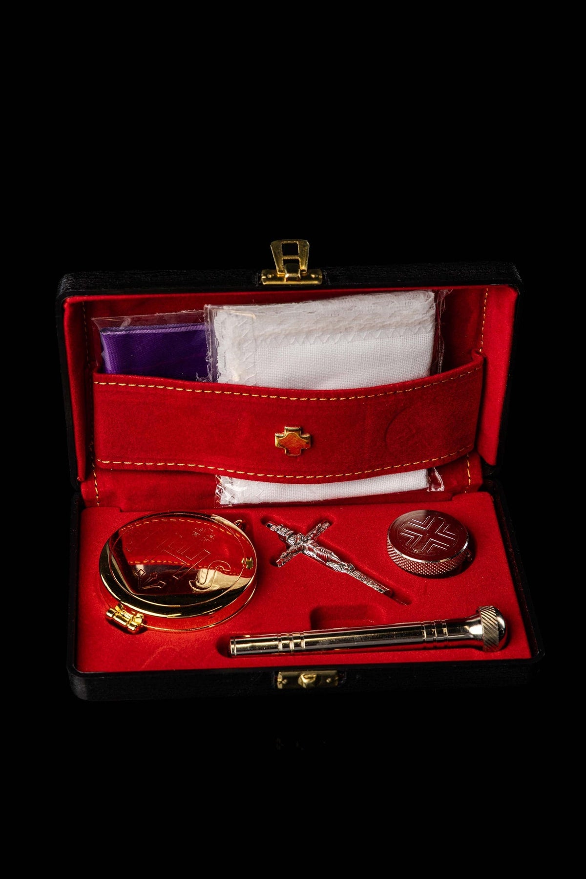 Front view of the red liturgical burse set with gold stitching, cross clasp and metal equipment