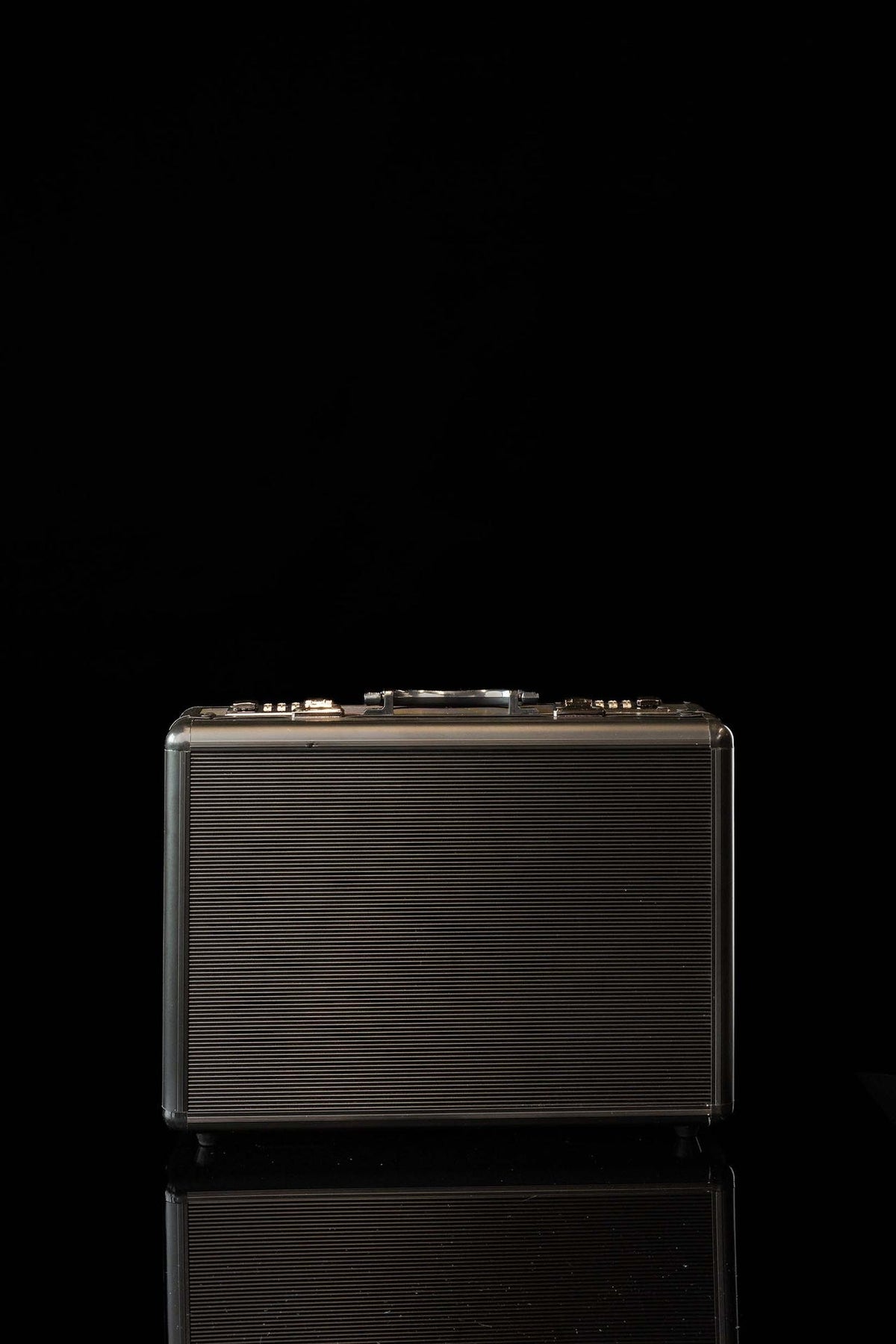 Front view of a black Mission Suitcase Equipped with Liturgical Equipment with ribbed exterior