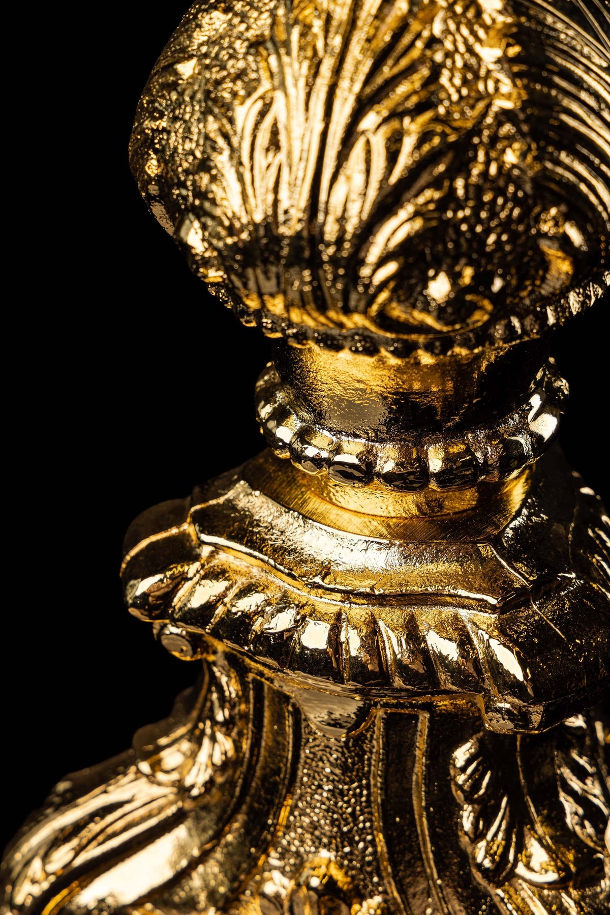 Close-up of a monstrance with gold-plated Baroque details on the stem and base