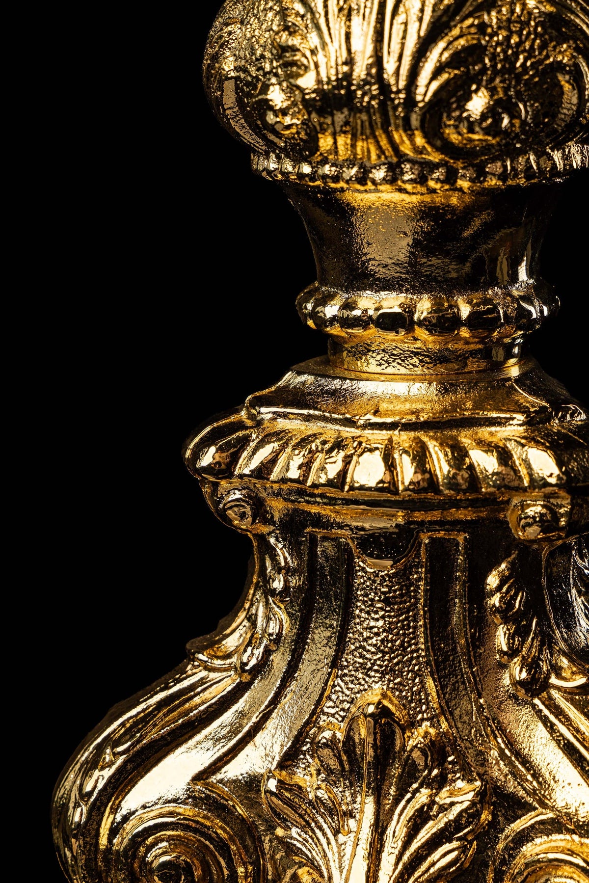Side close-up of a monstrance with gold-plated Baroque scrollwork and floral details