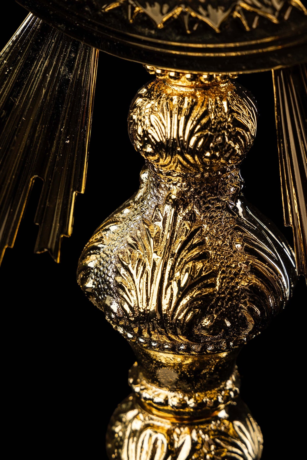Close-up of the monstrance showing a gold-plated Baroque ornament on the stem