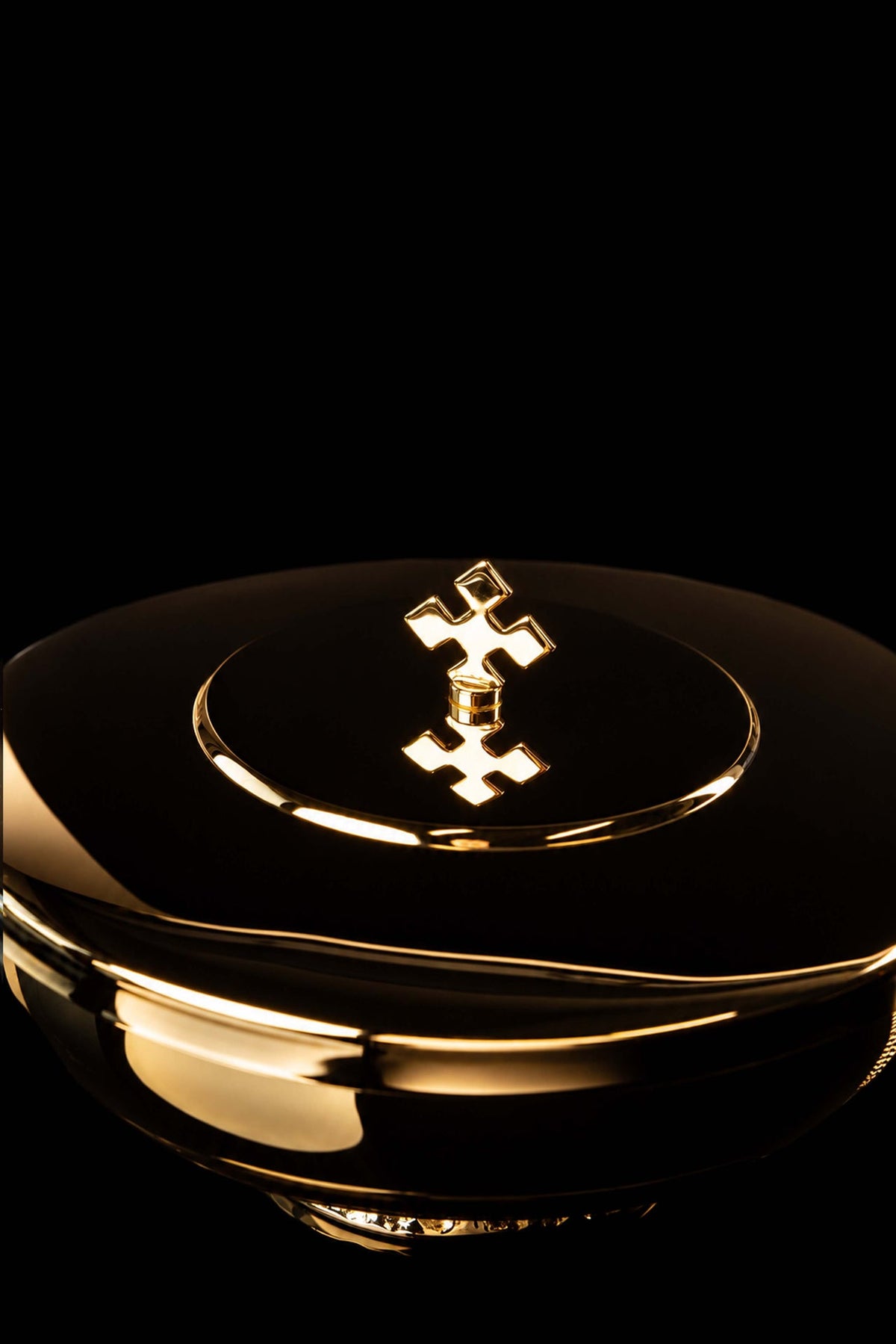 Top close-up of the gold-plated brass ciborium showing its cross finial and circular lid detail
