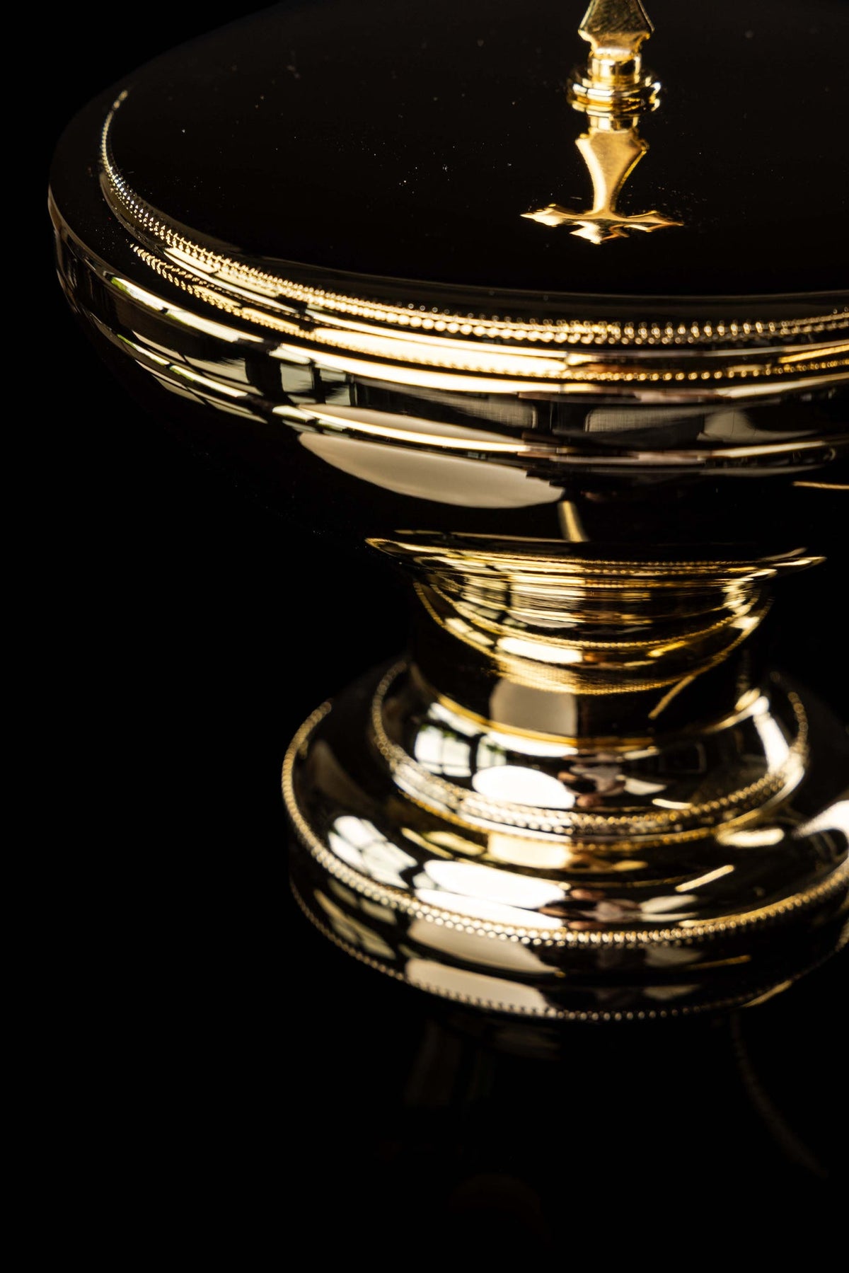 Close-up of the ciborium's decorative cross and lid rim
