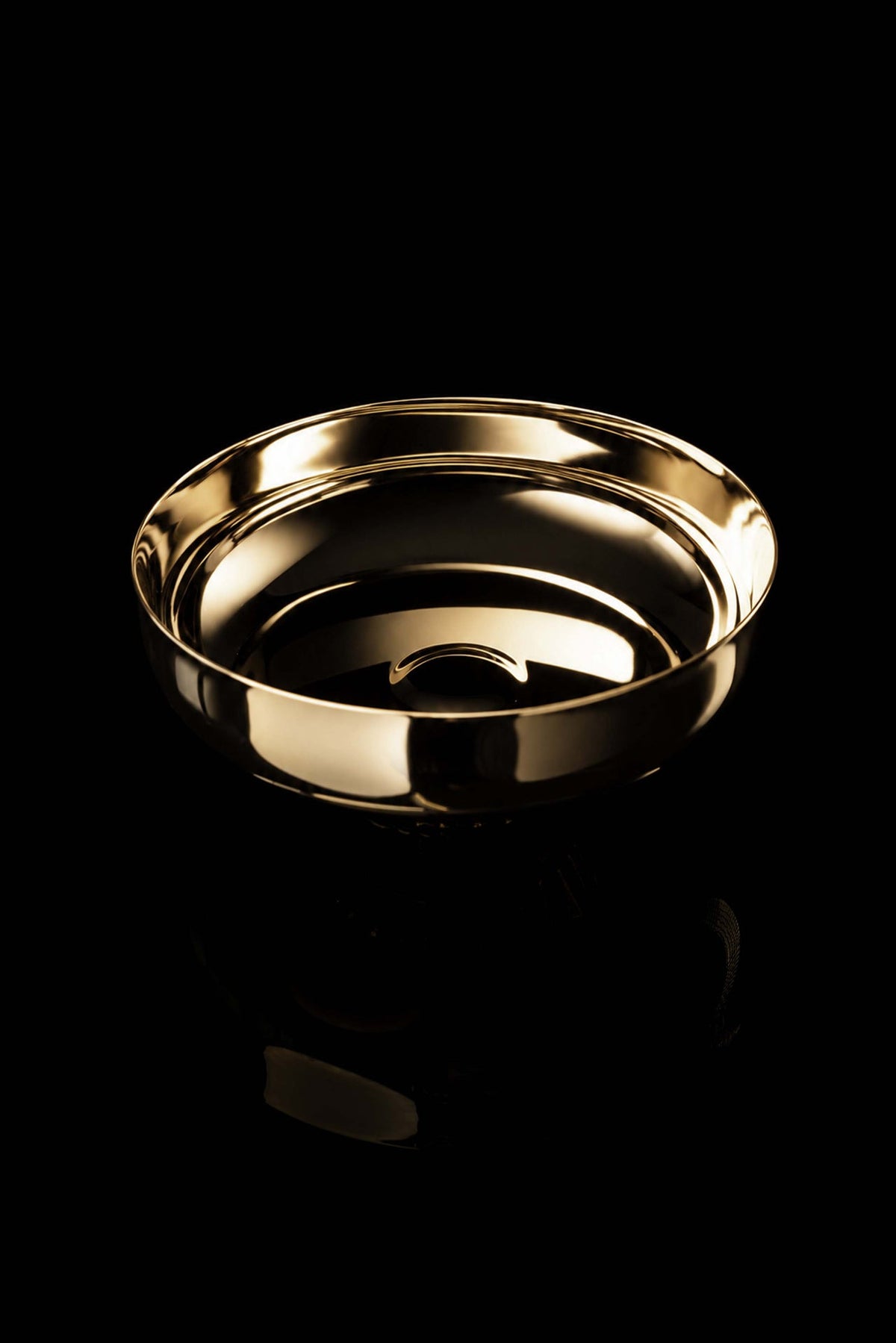 Top view of the gold-plated paten showing its smooth interior and raised rim