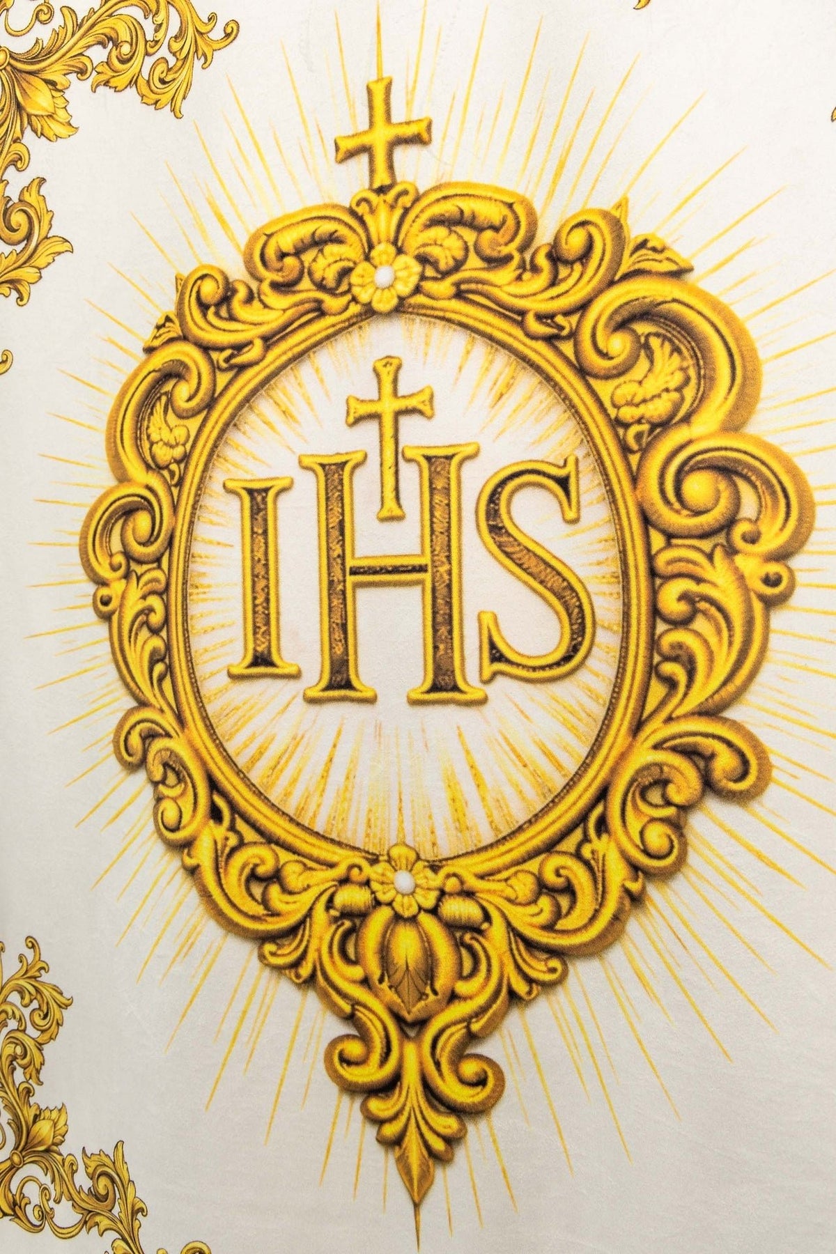 Close-up of a double-sided printed liturgical banner with the Sacred Heart of Jesus and IHS Christogram, gold design