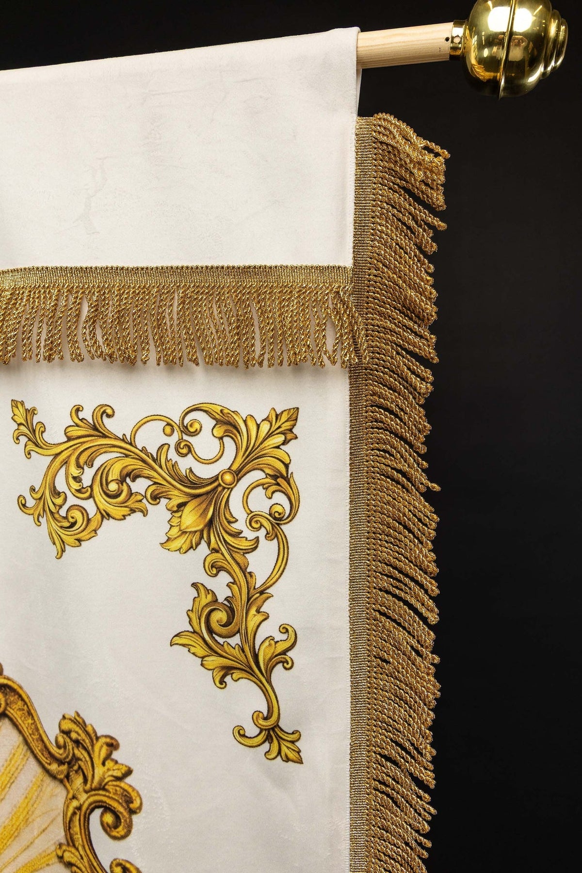 Side detail of the banner showing gold fringe and ornate gold scrollwork