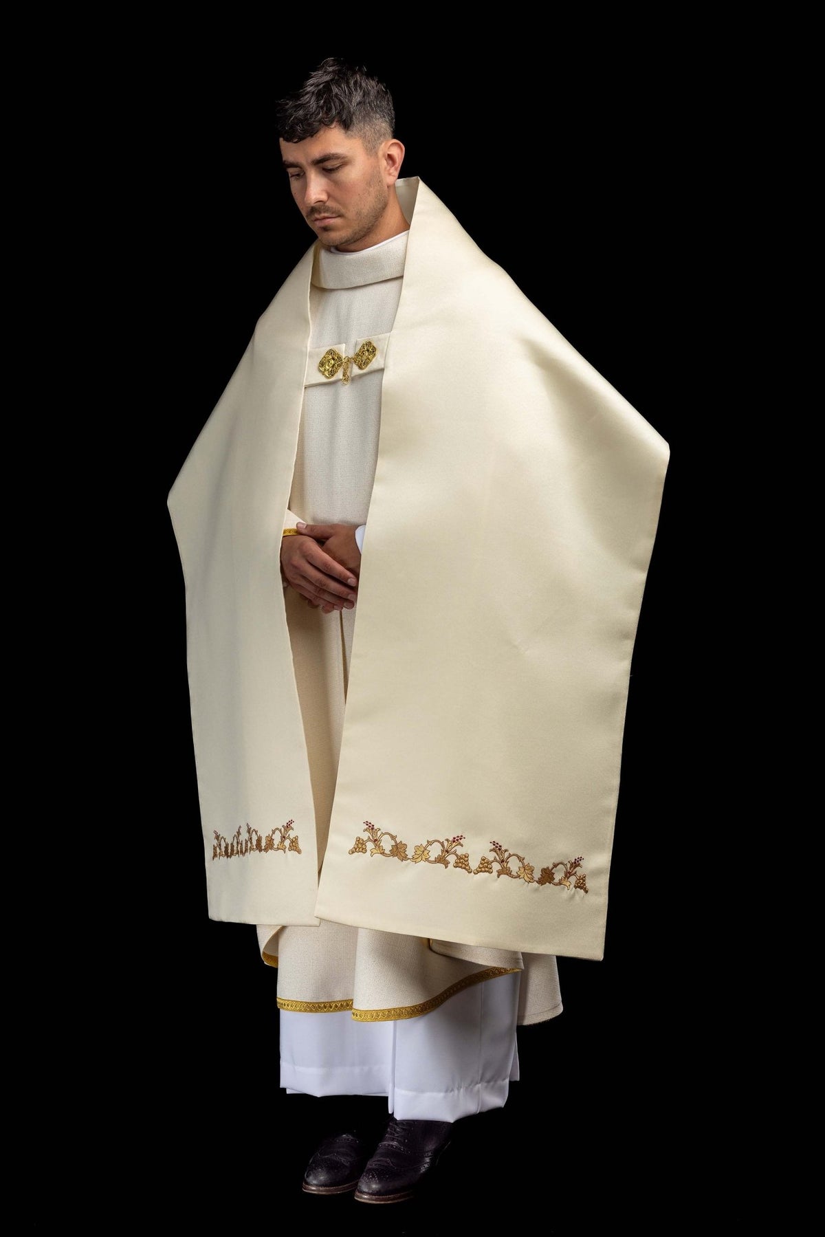 Front worn view of the humeral veil showing grapevine embroidery along the lower edges
