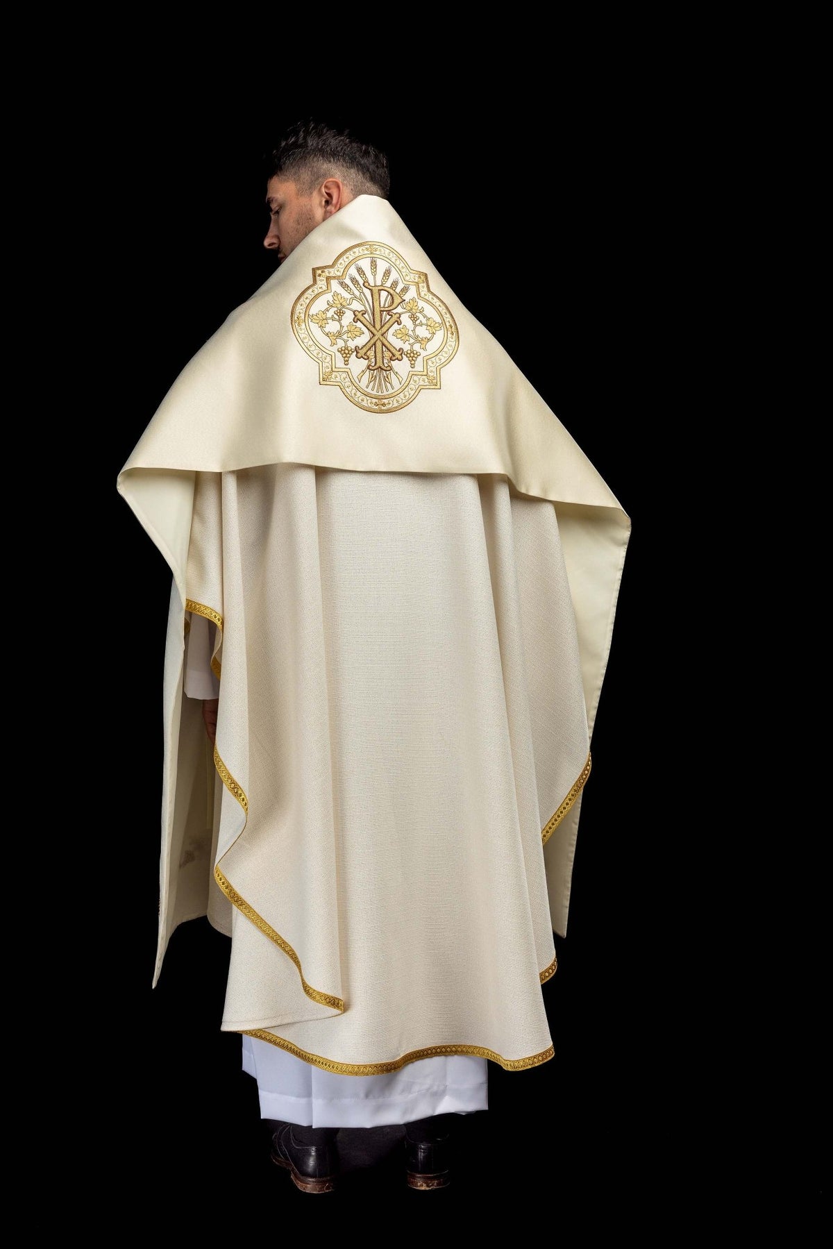 Full back view of the ecru humeral veil with gold edging and embroidered PAX emblem