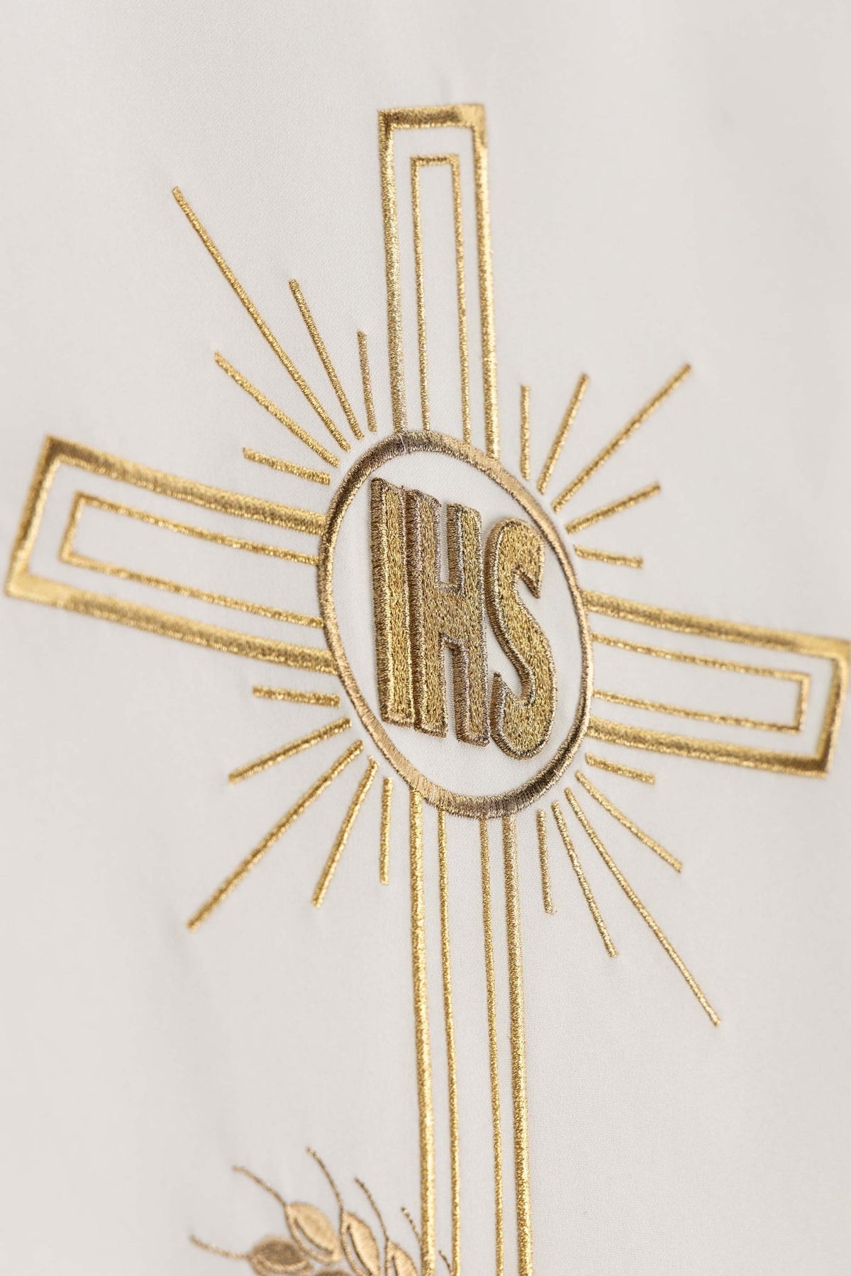 Angled close-up of the ecru lectern cloth showing gold IHS cross embroidery