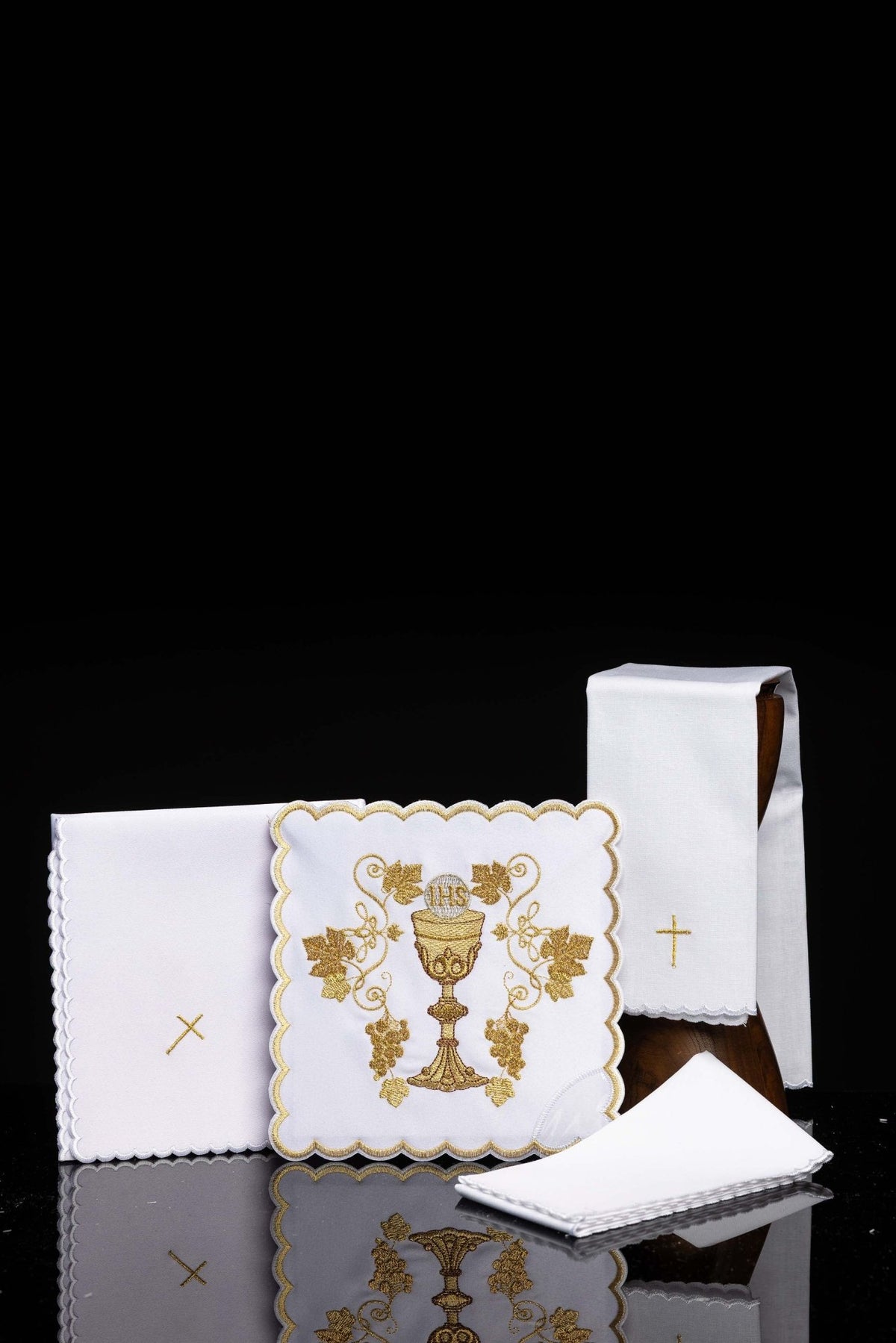 Front view of embroidered chalice linens set with a chalice motif, white linens with gold embroidery and scalloped edges