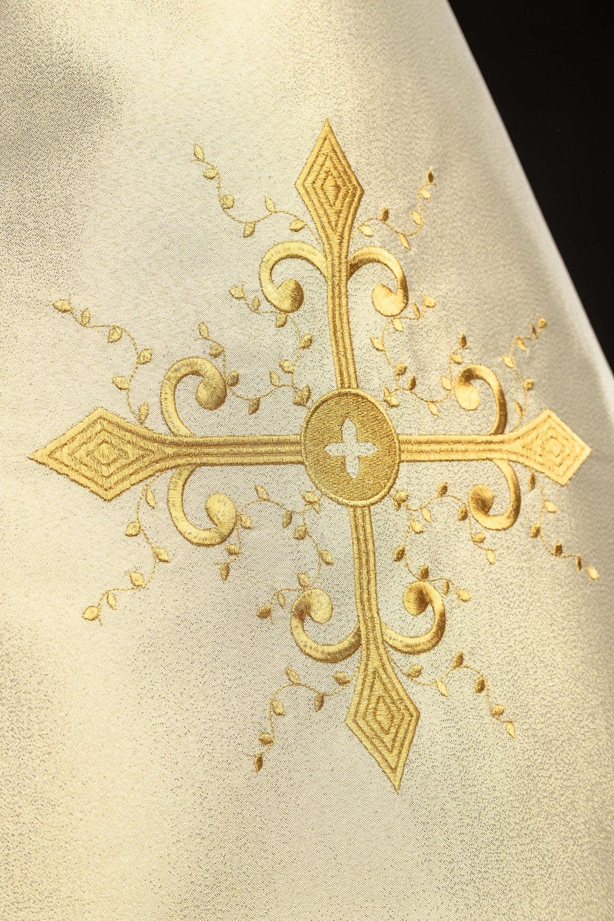 Close-up of the humeral veil showing its ornate embroidered gold cross
