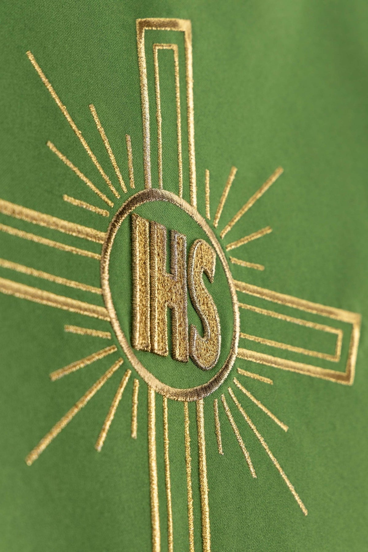 Close-up of the green lectern cloth showing the gold IHS cross embroidery