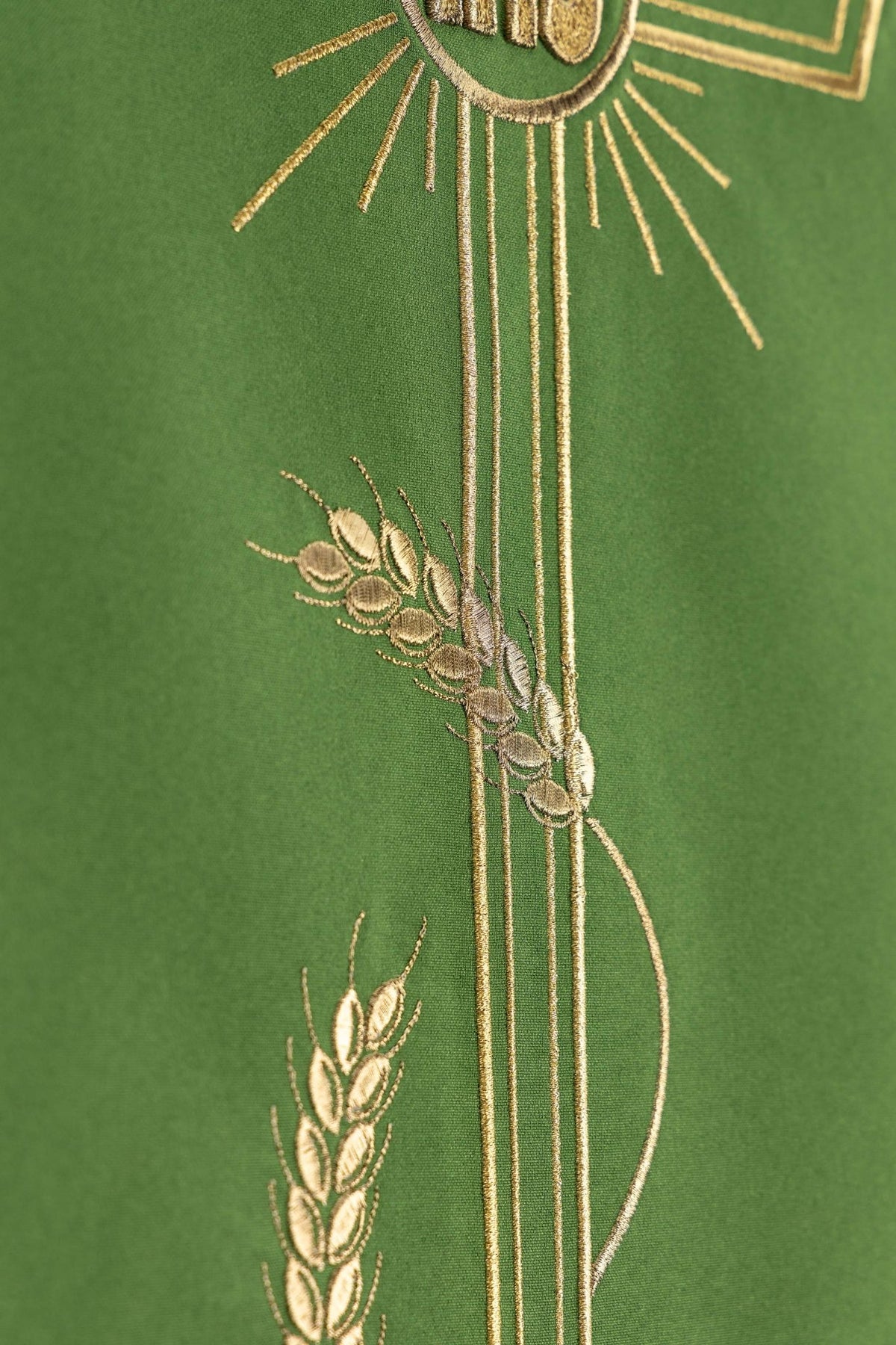 Detail view of the green lectern cloth showing embroidered wheat stalks and cross lines