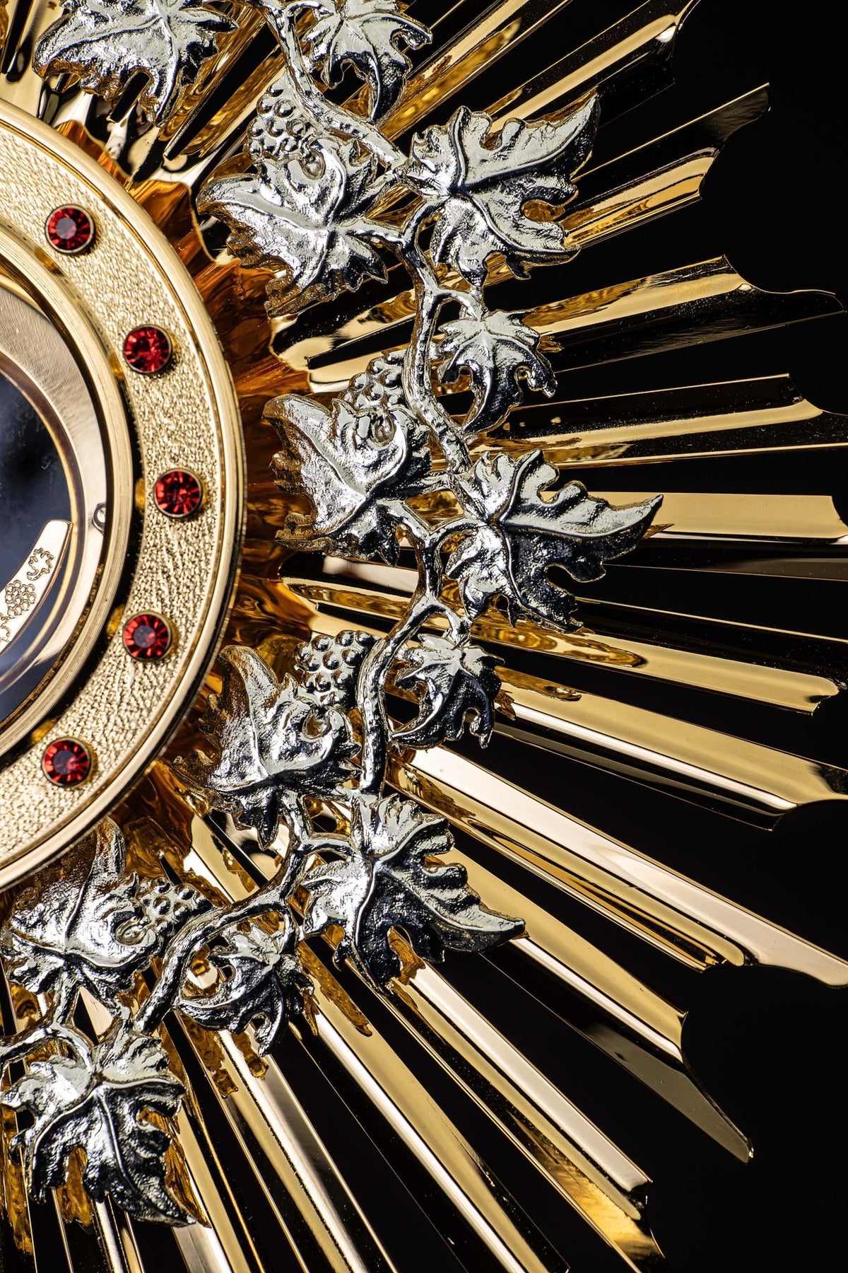 Close-up of the monstrance showing silver-tone grapevine and gilded sunburst rays