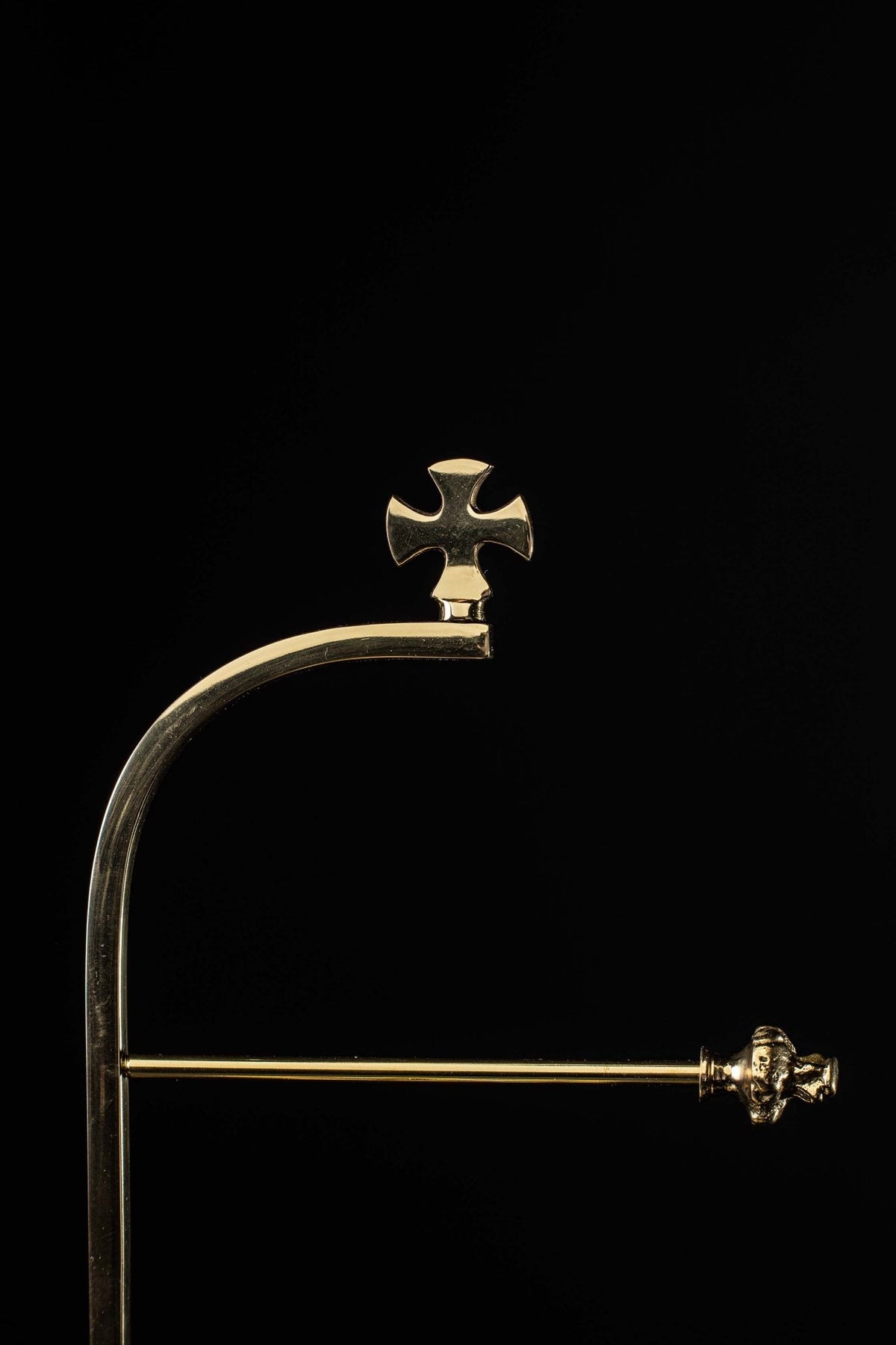 Close-up of the brass purificator hanger cross finial and horizontal support