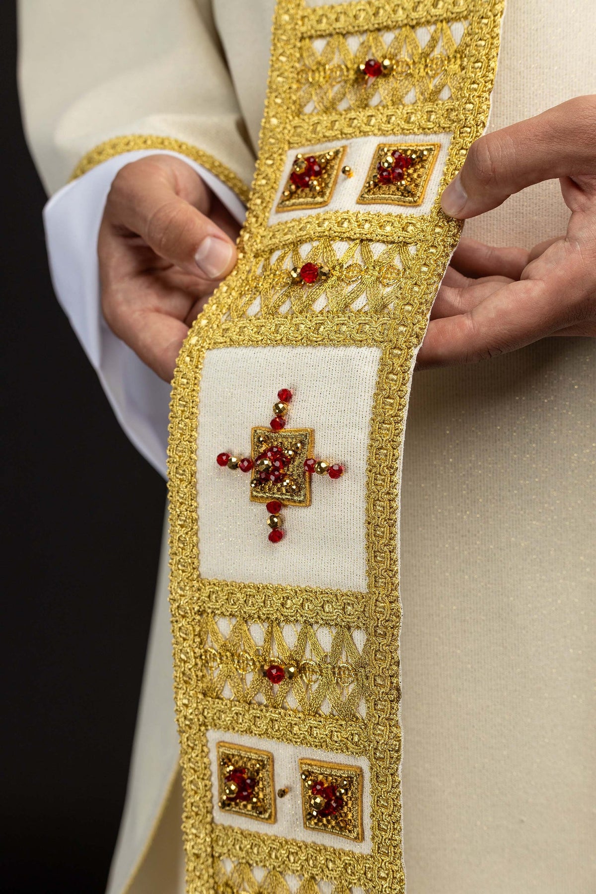 Detail of the chasuble panel showing paired square red and gold stone motifs