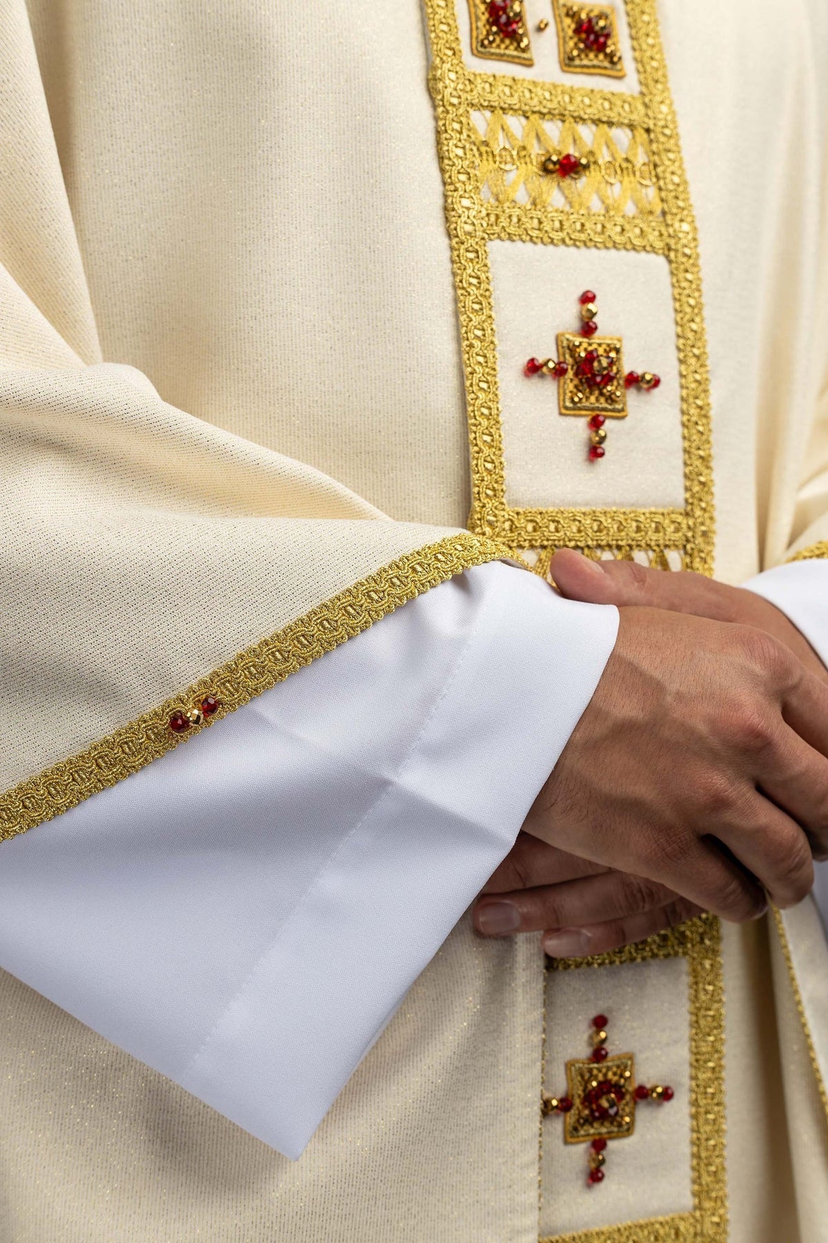 Close-up of the chasuble jeweled cross with red and gold stones
