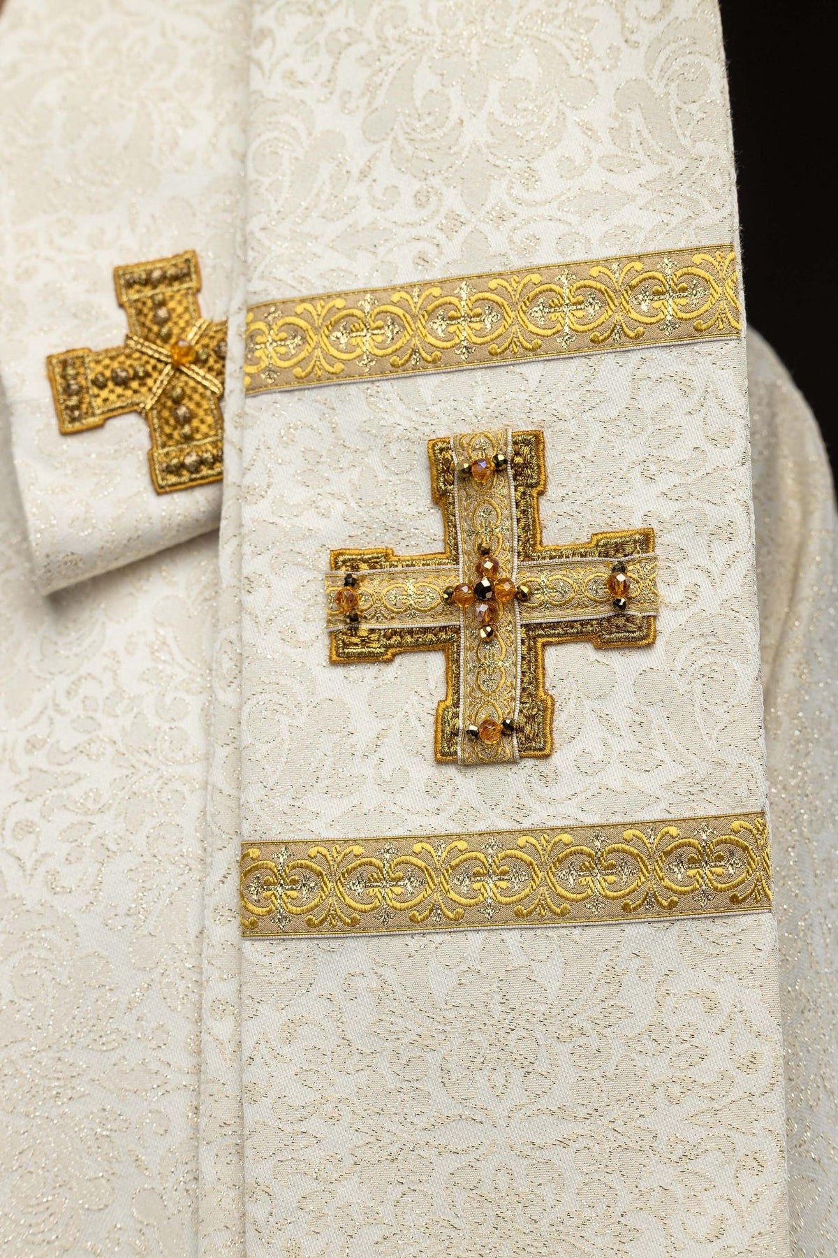 Detail view of the chasuble with matching gold-trimmed pieces and tassels