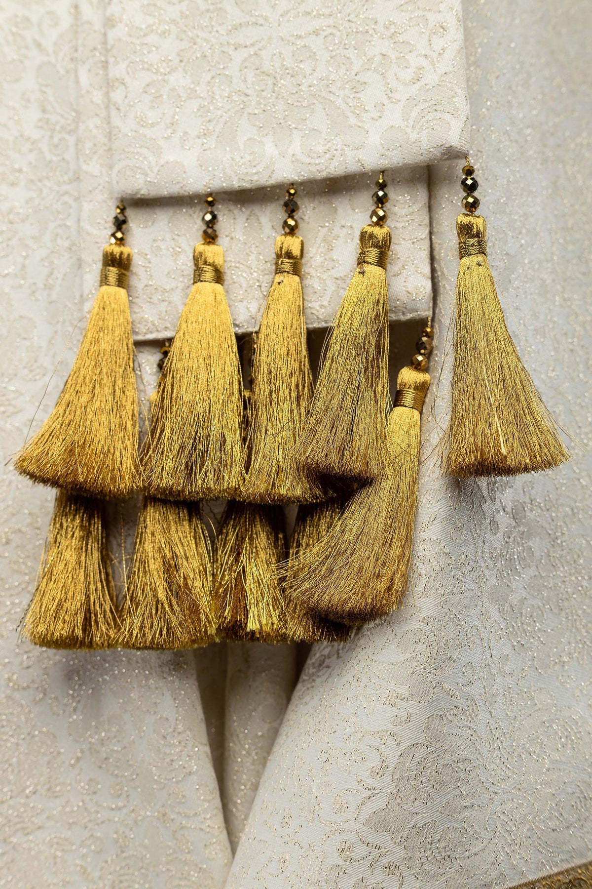 Close-up of gold tassels attached to the chasuble