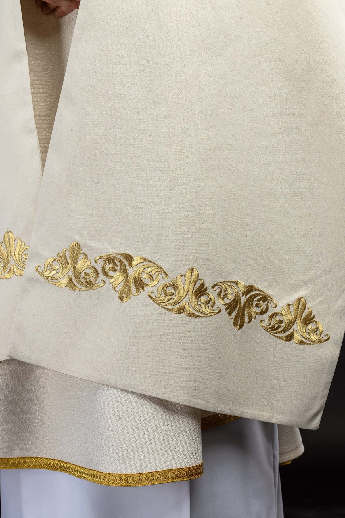 Lower front view of the humeral veil with a gold embroidered vine border and trim