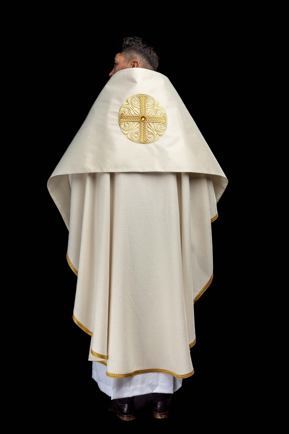 Full back view of the humeral veil, ecru with gold edging and an embroidered cross