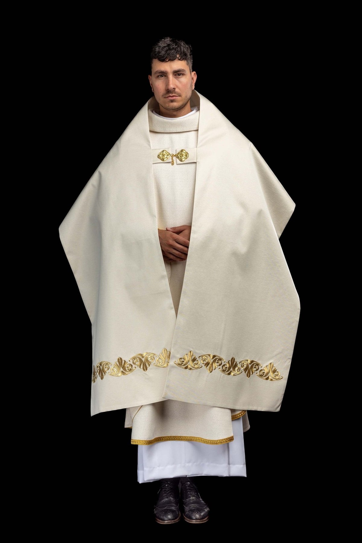 Full front view of the humeral veil with gold vine embroidery along the lower edge