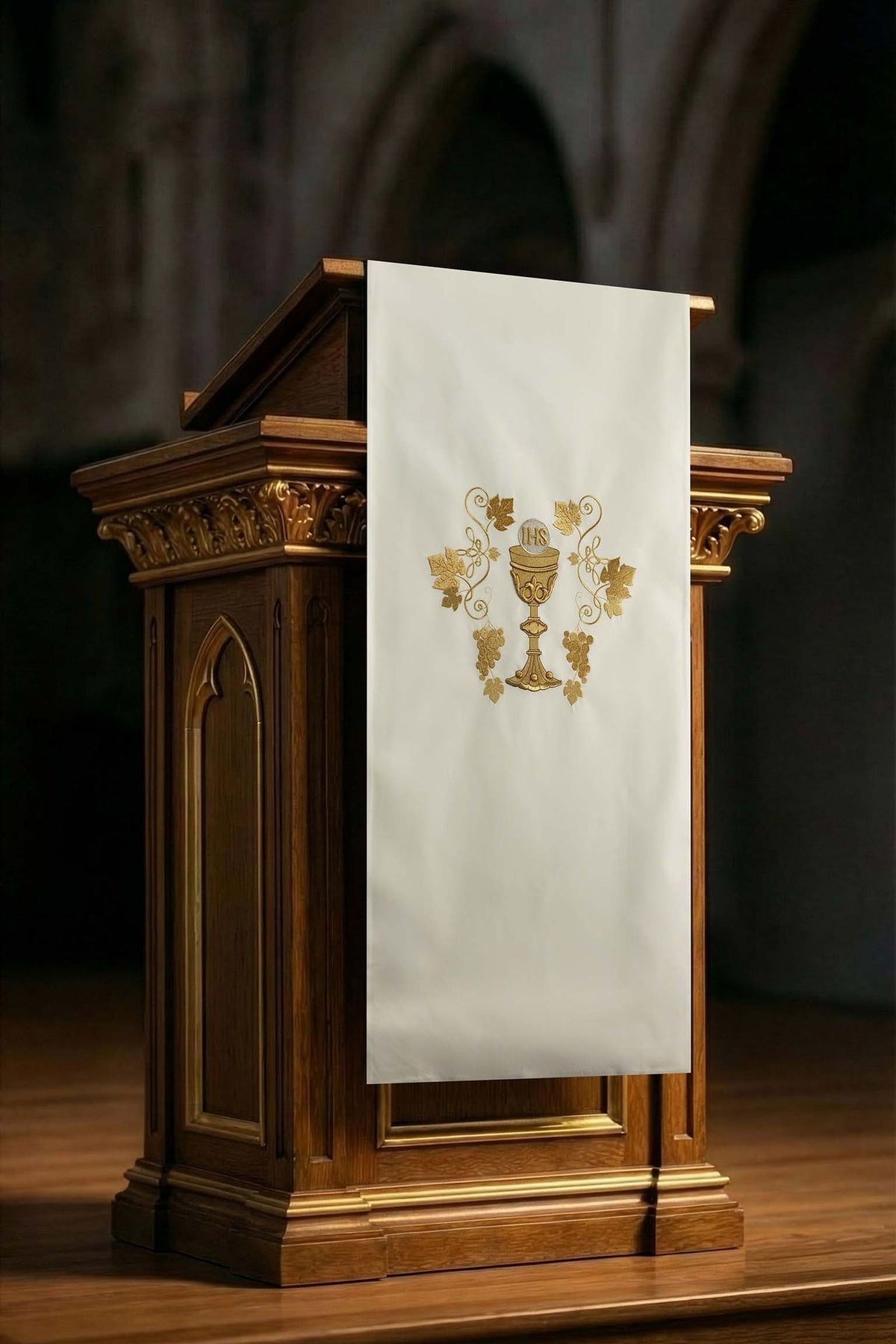 Front view of an ecru church lectern cover embroidered with a chalice motif in gold